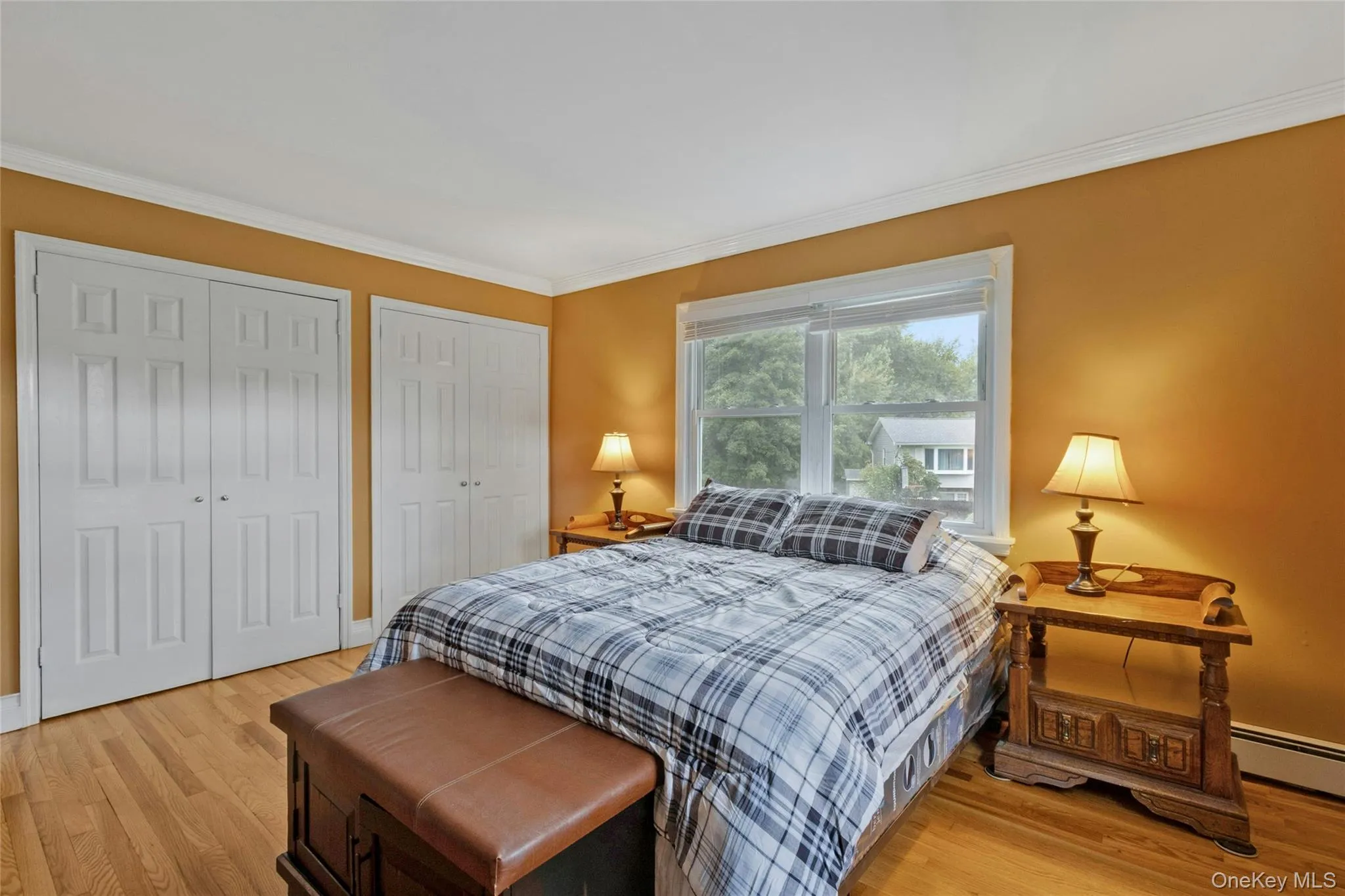 Crown molding detail, wood-finish flooring, and white trim Crown molding detail, wood-finish flooring, and white trim