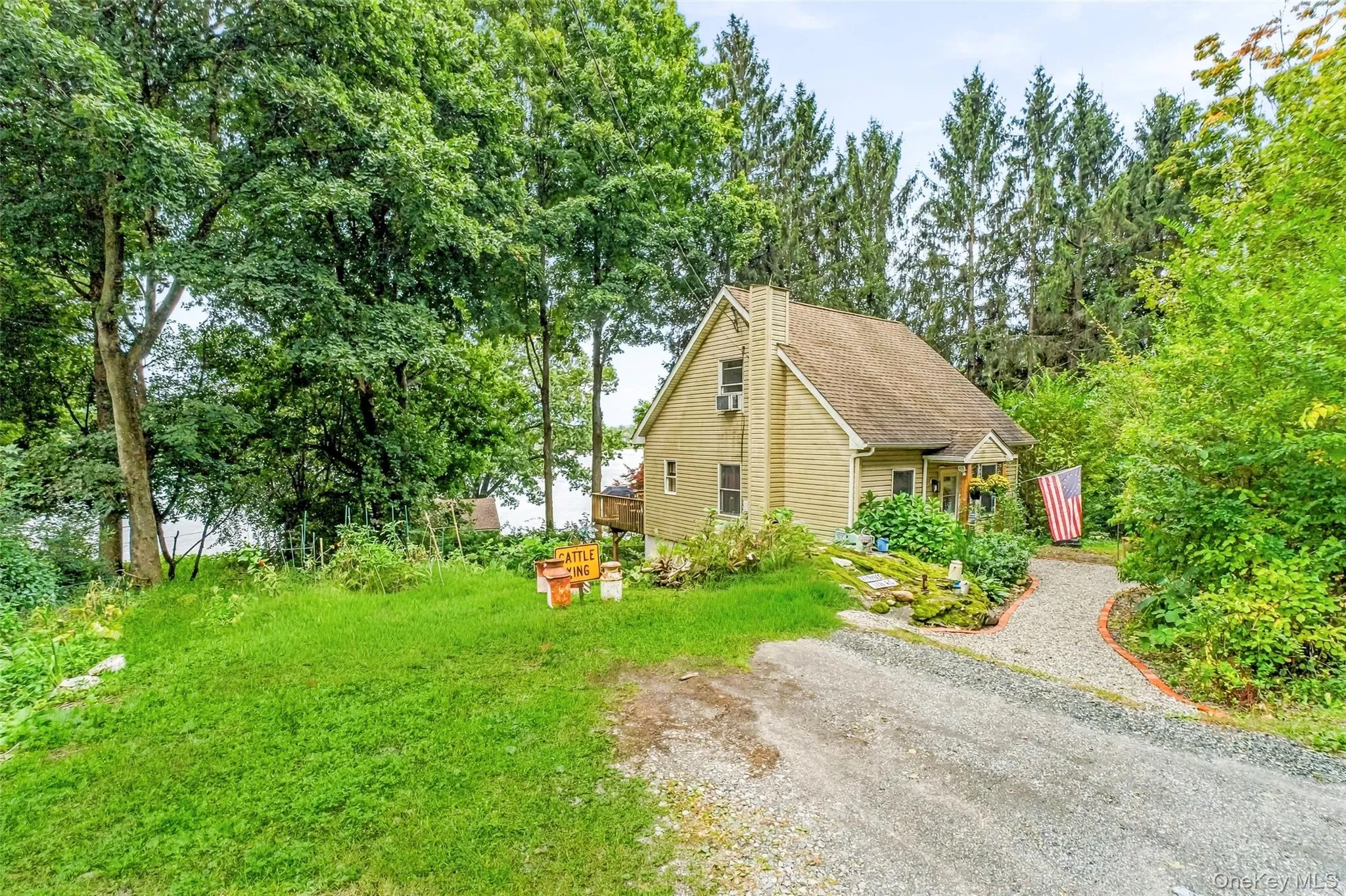View of garden (left center of photo), house to the right and lake behind from front corner of off street parking area View of garden (left center of photo), house to the right and lake behind from front corner of off street parking area