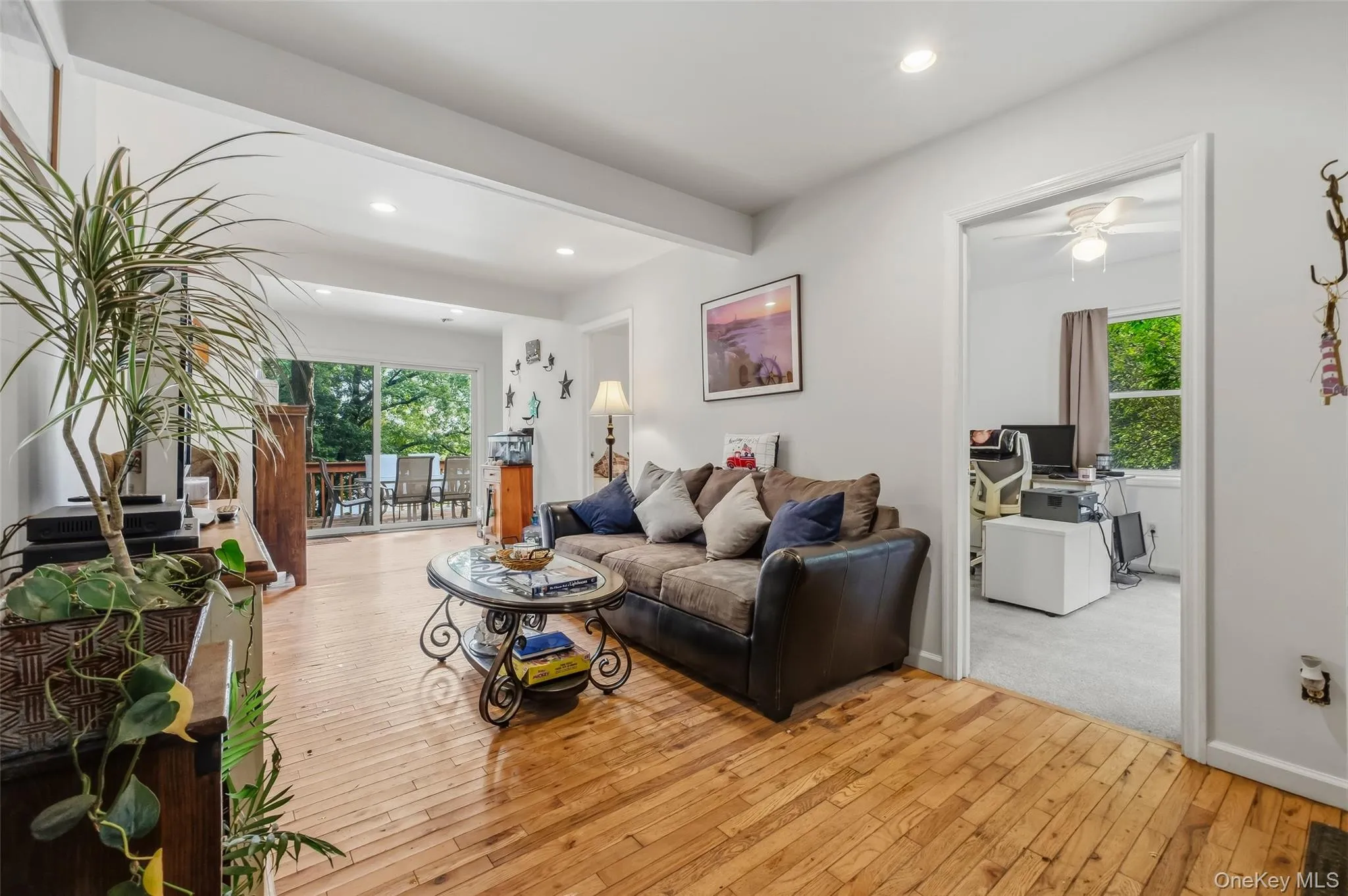 with hardwood floors, sliding glass doors and view of lake with hardwood floors, sliding glass doors and view of lake