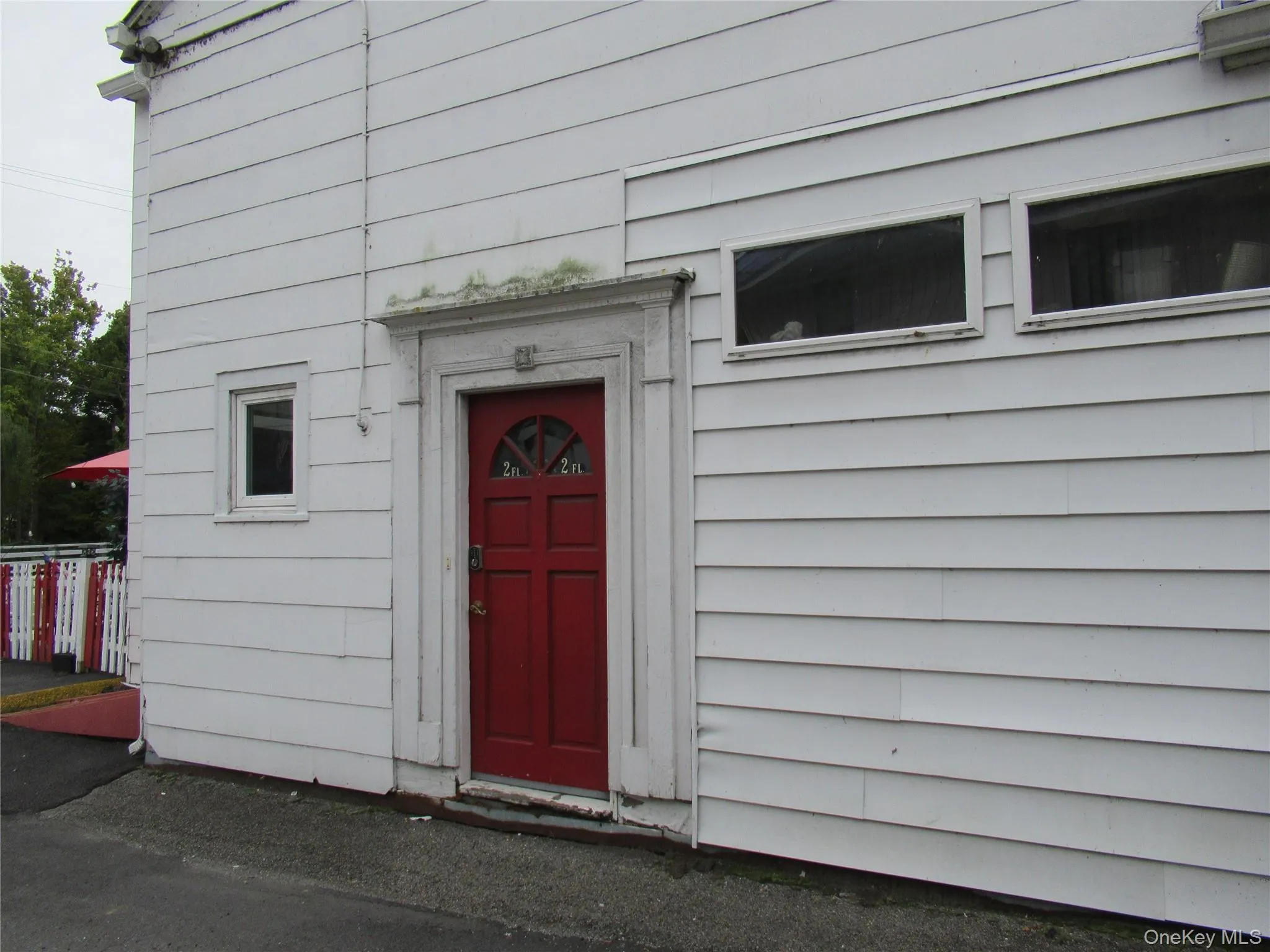 Red side door of building - restaurant on the front Red side door of building - restaurant on the front