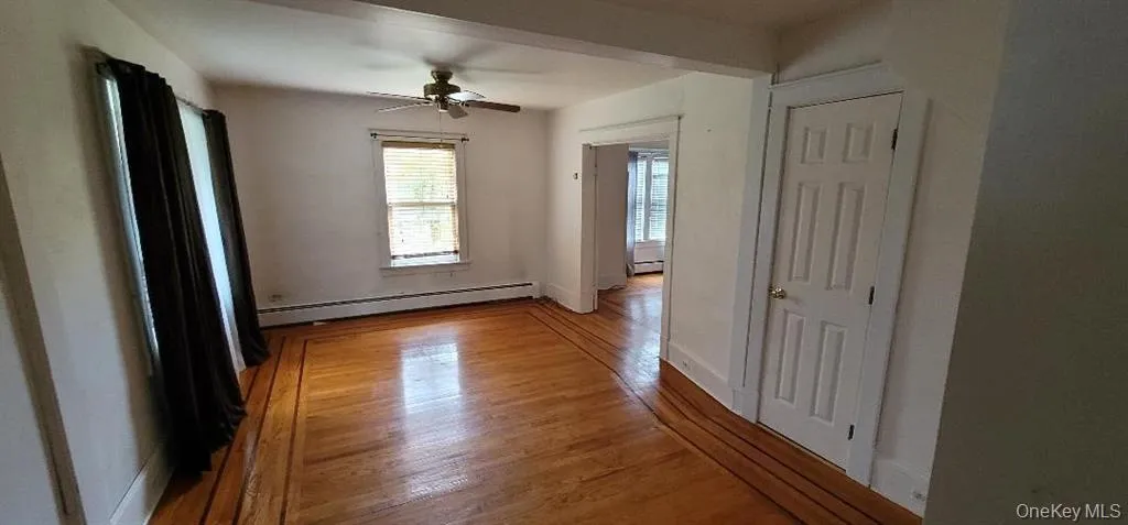 hardwood / wood-style flooring, a baseboard heating unit, and ceiling fan hardwood / wood-style flooring, a baseboard heating unit, and ceiling fan