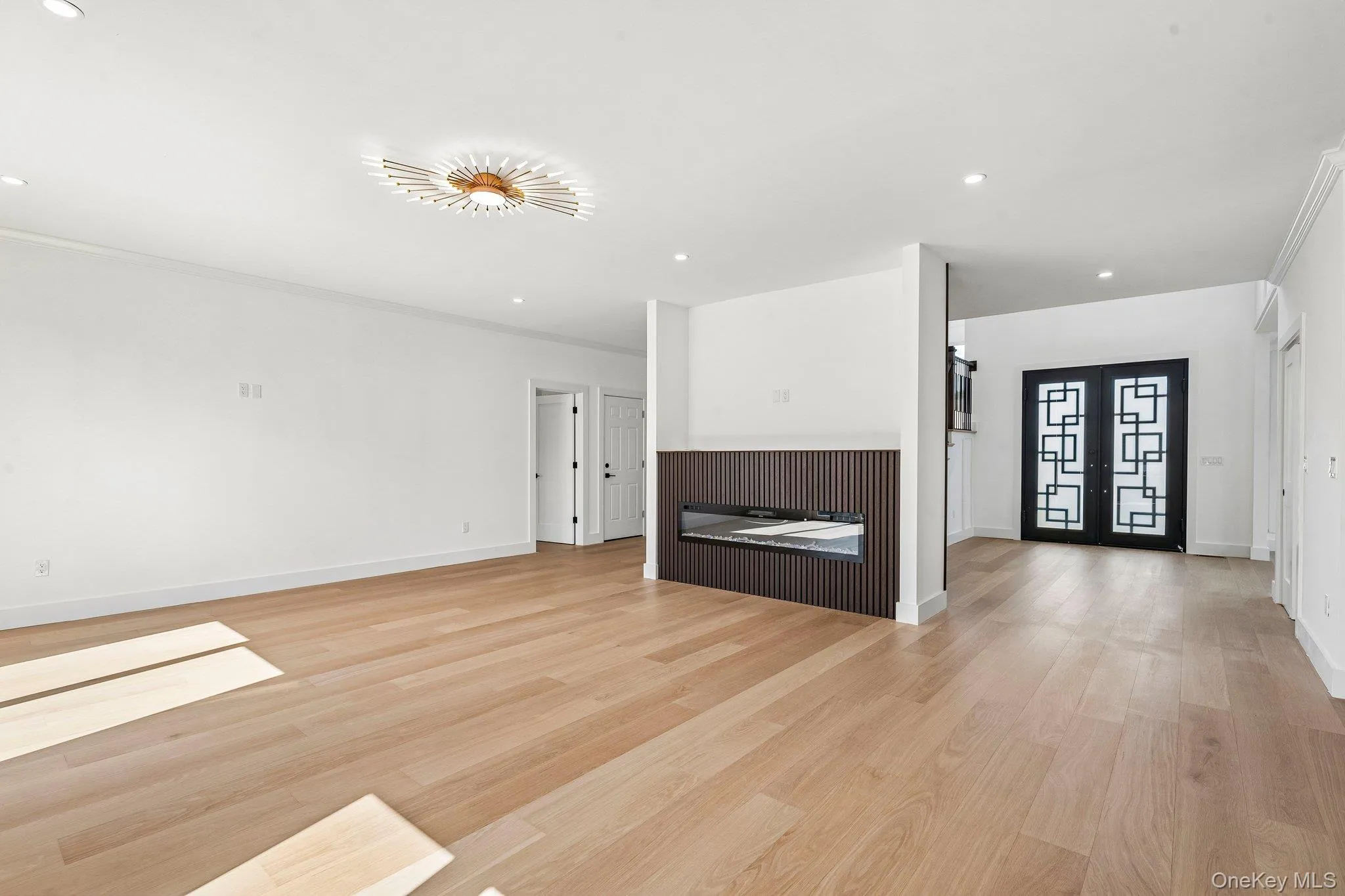 Expansive room featuring light wood-finish flooring and recessed lighting Expansive room featuring light wood-finish flooring and recessed lighting