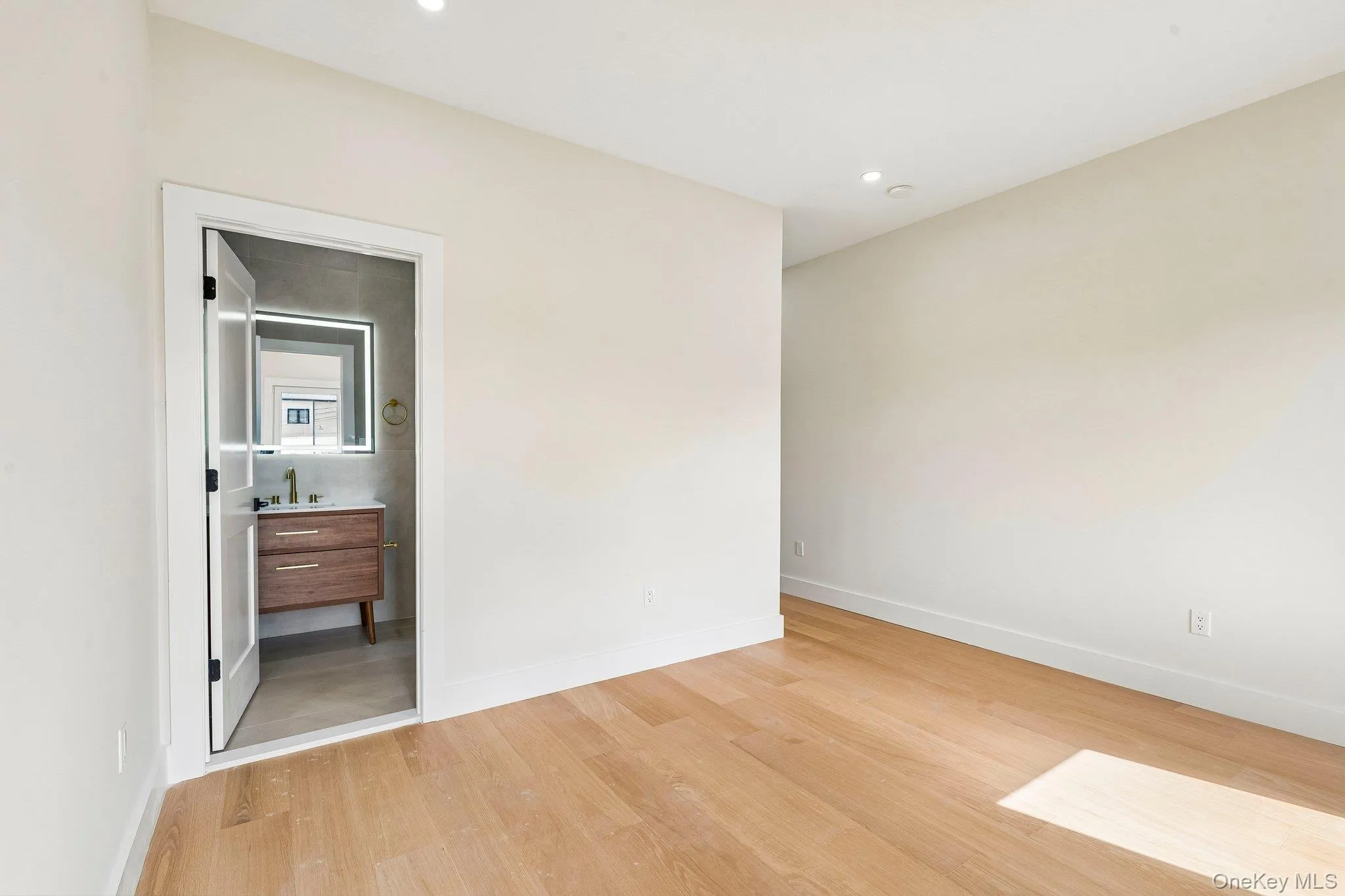 Light wood-finish flooring with recessed lighting Light wood-finish flooring with recessed lighting
