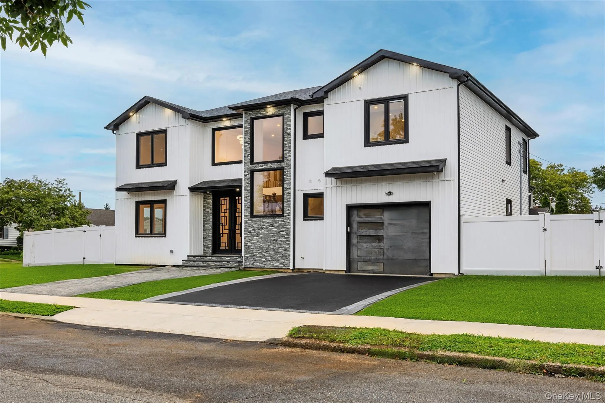 Contemporary exterior featuring white vertical siding and dark-trimmed windows Contemporary exterior featuring white vertical siding and dark-trimmed windows