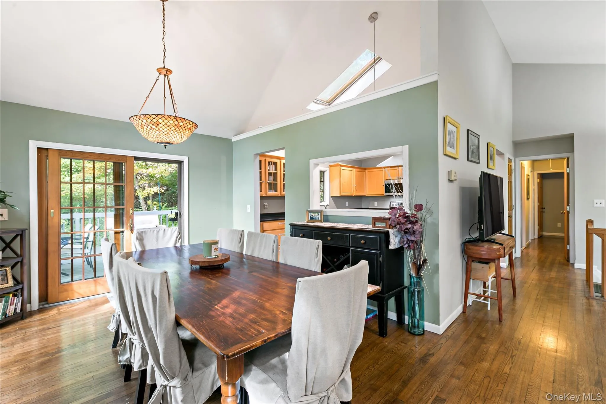 Formal dining room with sliders out to deck. Formal dining room with sliders out to deck.