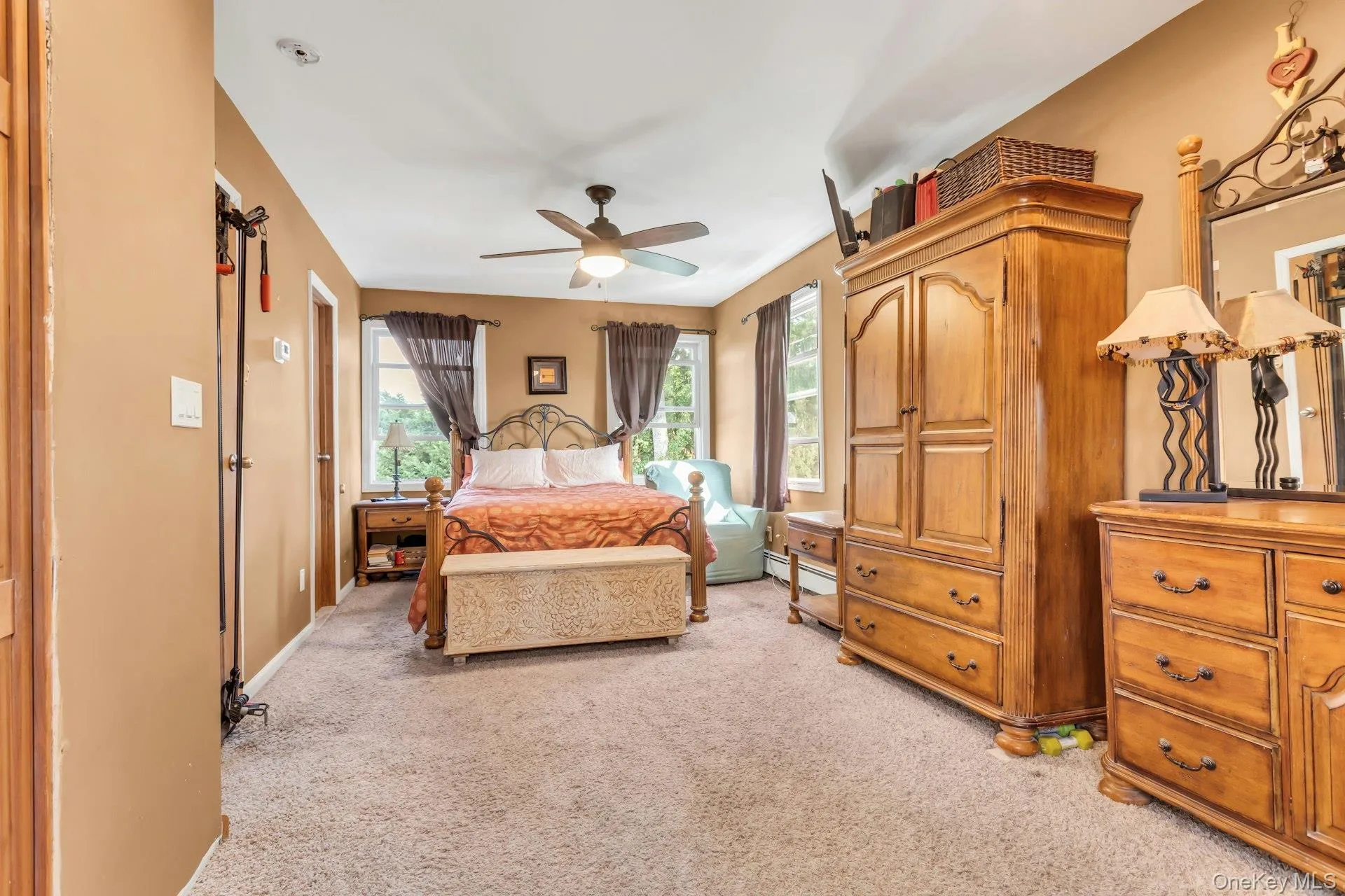 Carpeted flooring, ceiling fan, and multiple windows Carpeted flooring, ceiling fan, and multiple windows