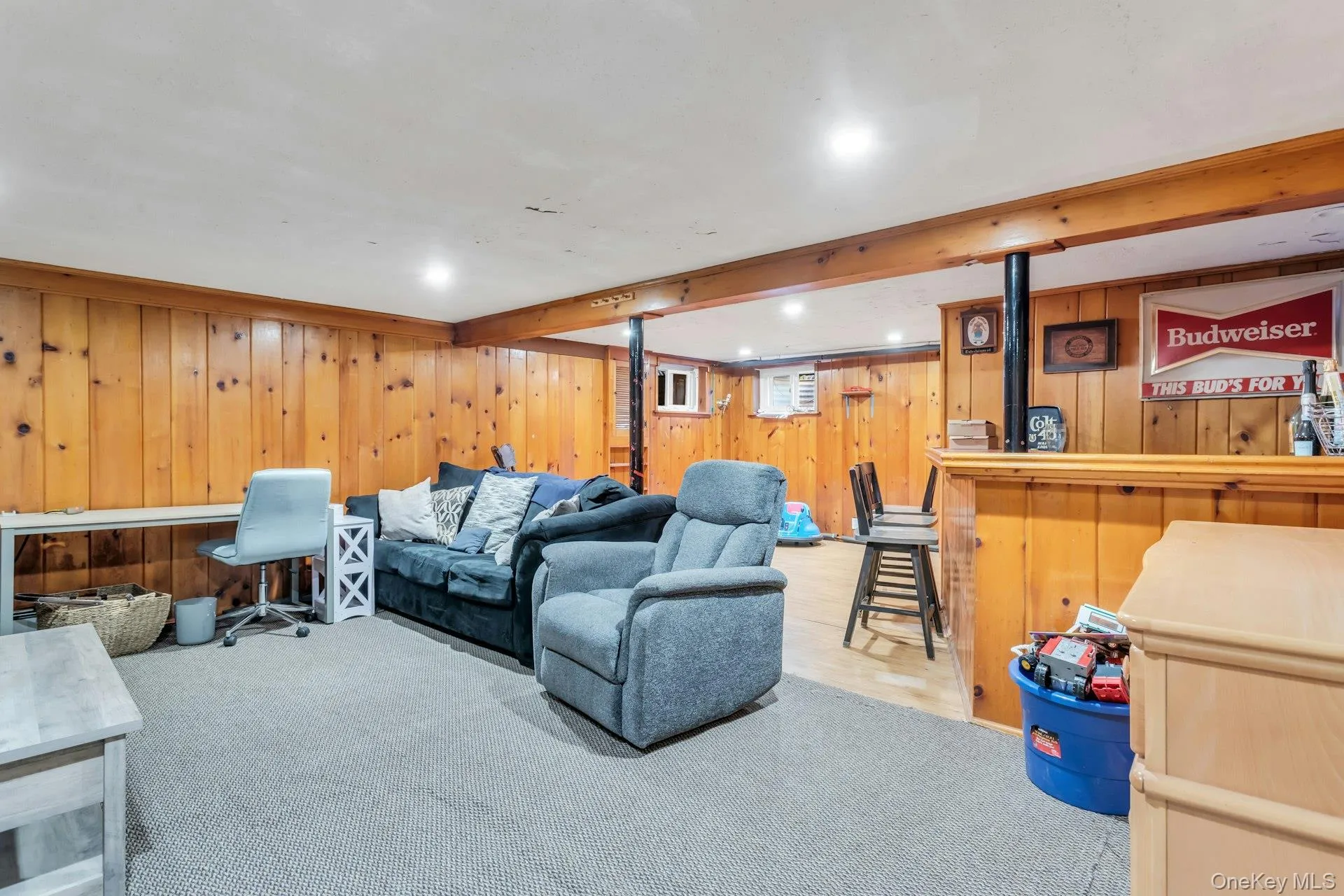 Wood paneling, recessed lighting, carpeted and wood-finish flooring, and a built-in bar Wood paneling, recessed lighting, carpeted and wood-finish flooring, and a built-in bar
