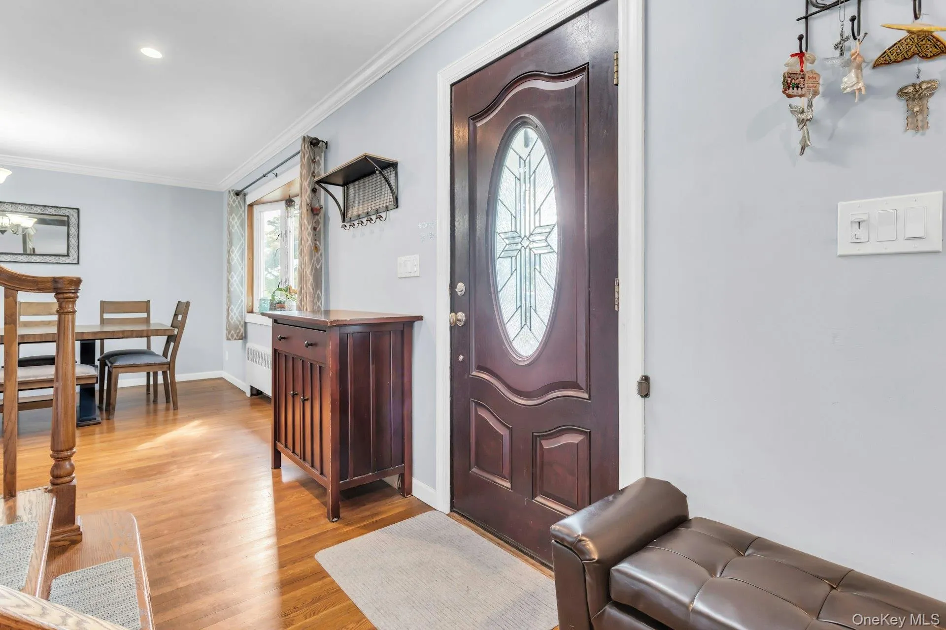 Hardwood flooring, recessed ceiling lighting, crown molding, and a decorative front entry door with an oval glass insert Hardwood flooring, recessed ceiling lighting, crown molding, and a decorative front entry door with an oval glass insert