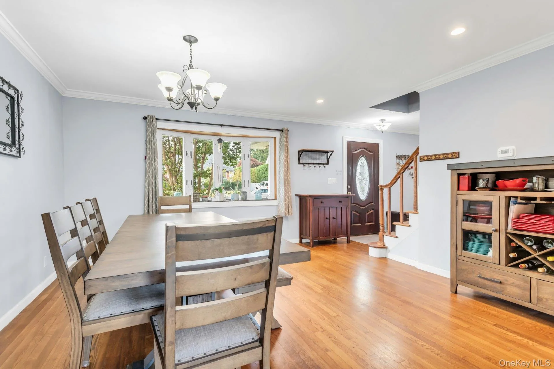 Hardwood flooring throughout, bay window, decorative chandelier, recessed lighting, and a stained wood entry door with oval glass insert Hardwood flooring throughout, bay window, decorative chandelier, recessed lighting, and a stained wood entry door with oval glass insert
