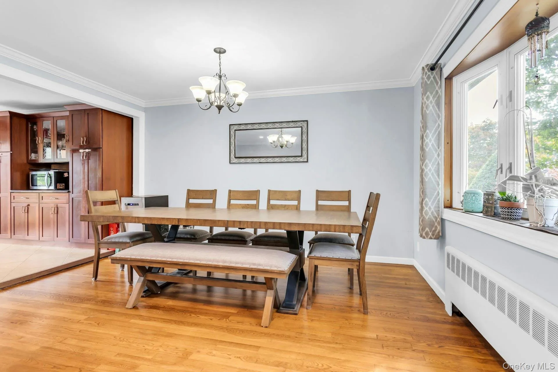 Wood-finish flooring with crown molding and a multi-pane window Wood-finish flooring with crown molding and a multi-pane window