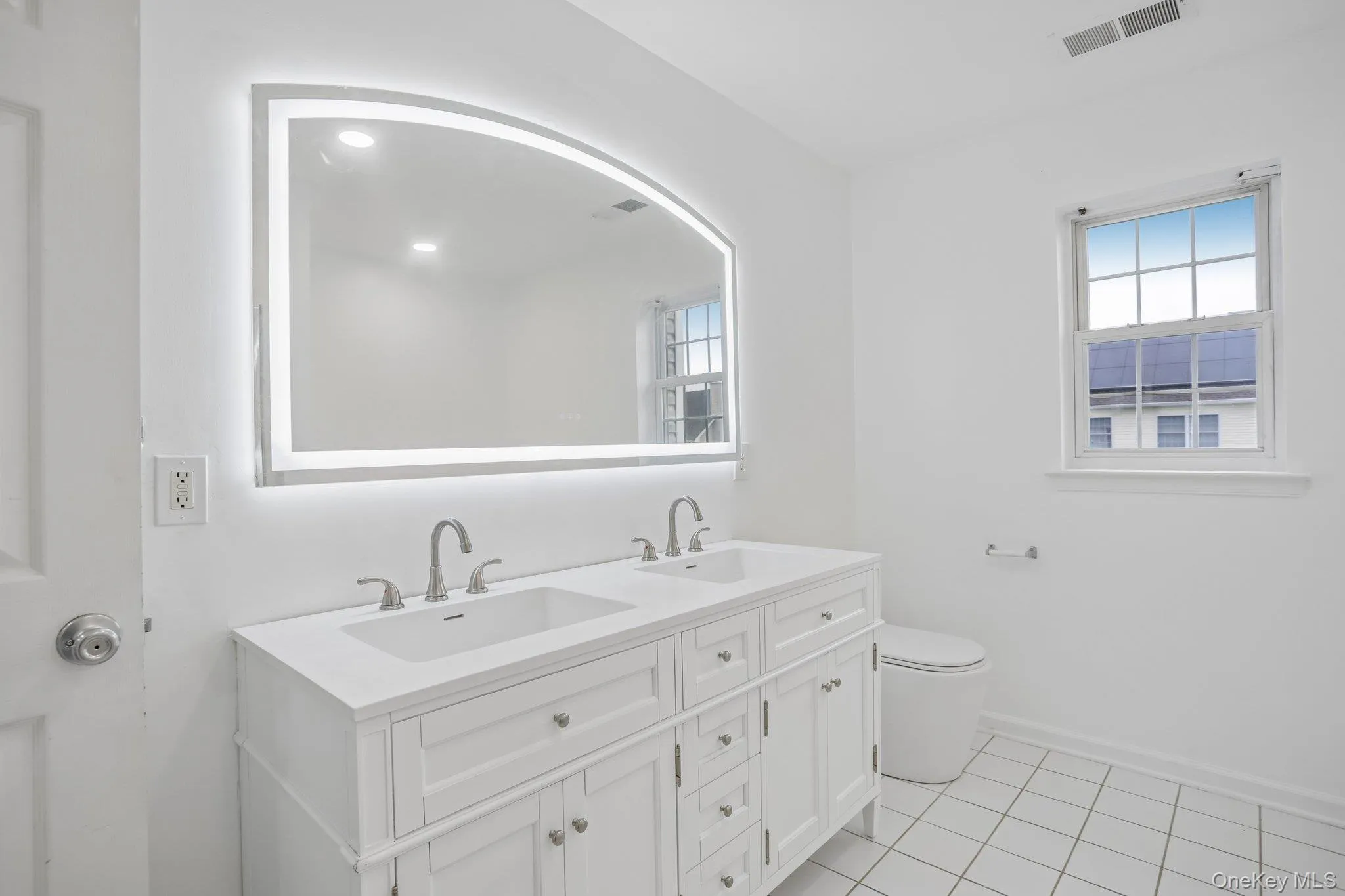 Brand new dual-sink cabinet, mirror and new toilet Brand new dual-sink cabinet, mirror and new toilet