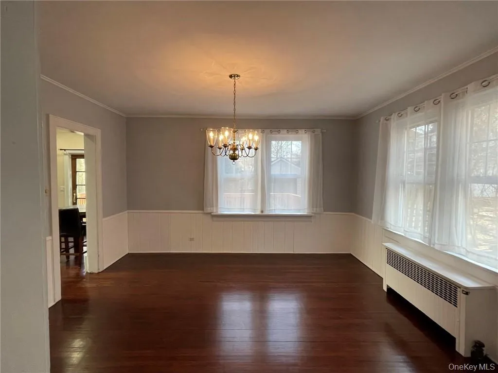 Dining room featuring natural light and chandelier. Access to kitchen and living room. Dining room featuring natural light and chandelier. Access to kitchen and living room.