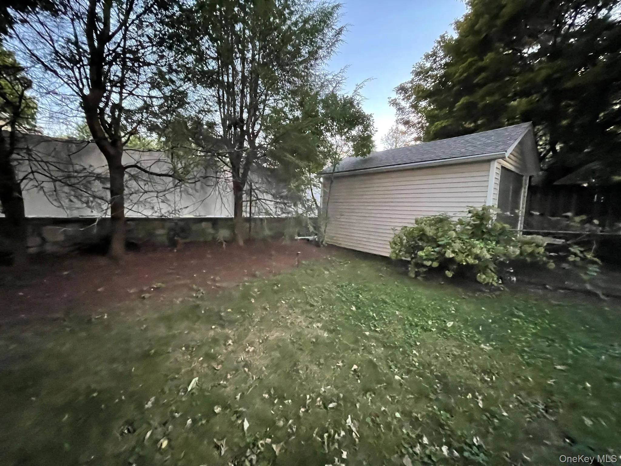 Fenced backyard featuring a storage unit Fenced backyard featuring a storage unit