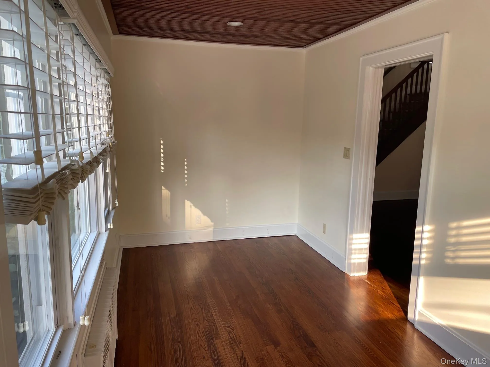 Office featuring dark wood-type flooring, crown molding and a pocket door Office featuring dark wood-type flooring, crown molding and a pocket door