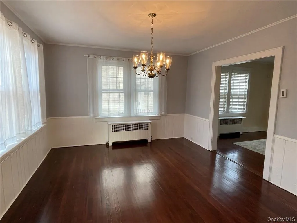Dining room featuring natural light and chandelier. Access to kitchen and living room. Dining room featuring natural light and chandelier. Access to kitchen and living room.