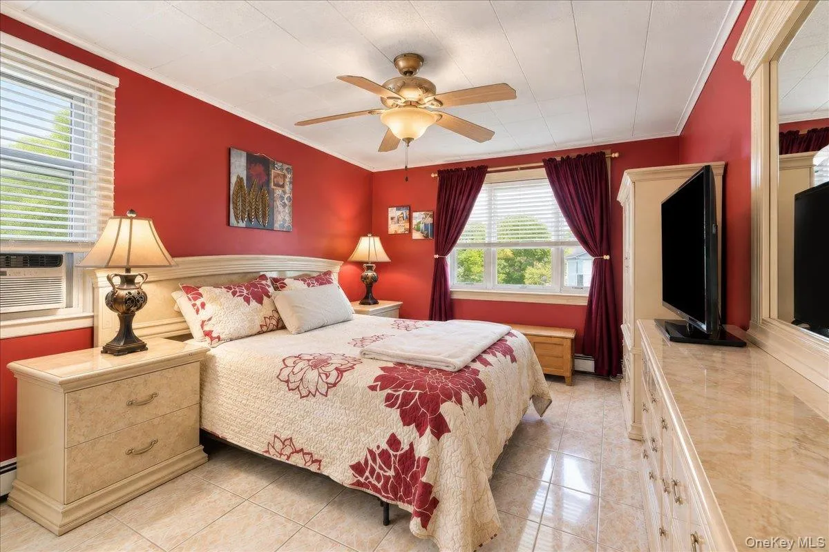 Recessed panel ceiling, ceiling fan with integrated lighting, tile flooring, window with blinds, and decorative crown molding Recessed panel ceiling, ceiling fan with integrated lighting, tile flooring, window with blinds, and decorative crown molding