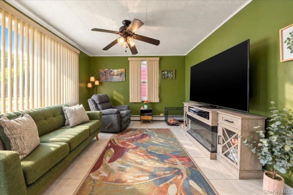 Recessed panel ceiling, ceiling fan with light fixture, vertical blinds, and tile flooring Recessed panel ceiling, ceiling fan with light fixture, vertical blinds, and tile flooring