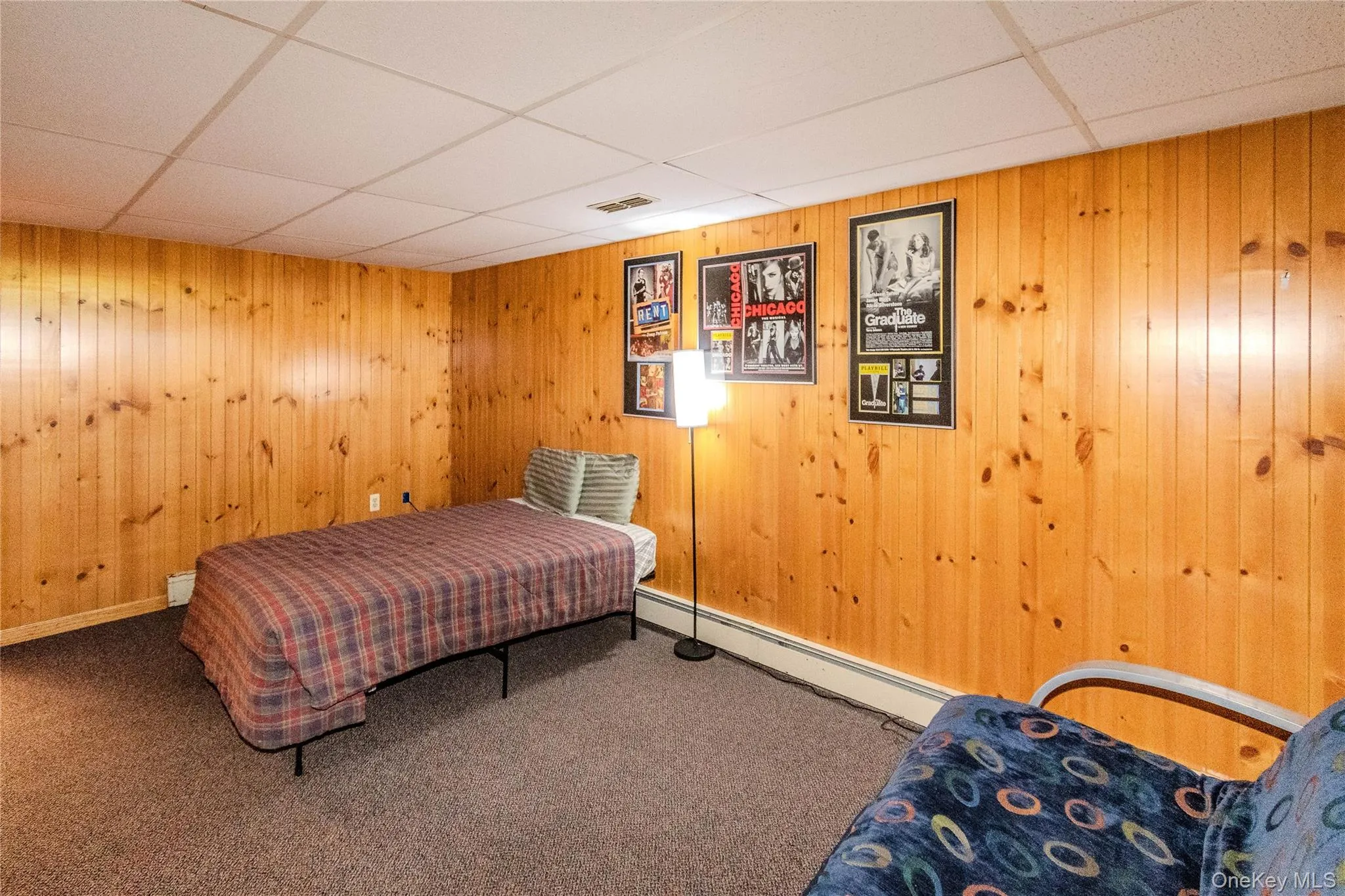 Wood paneling walls complement a drop ceiling with integrated lighting Wood paneling walls complement a drop ceiling with integrated lighting