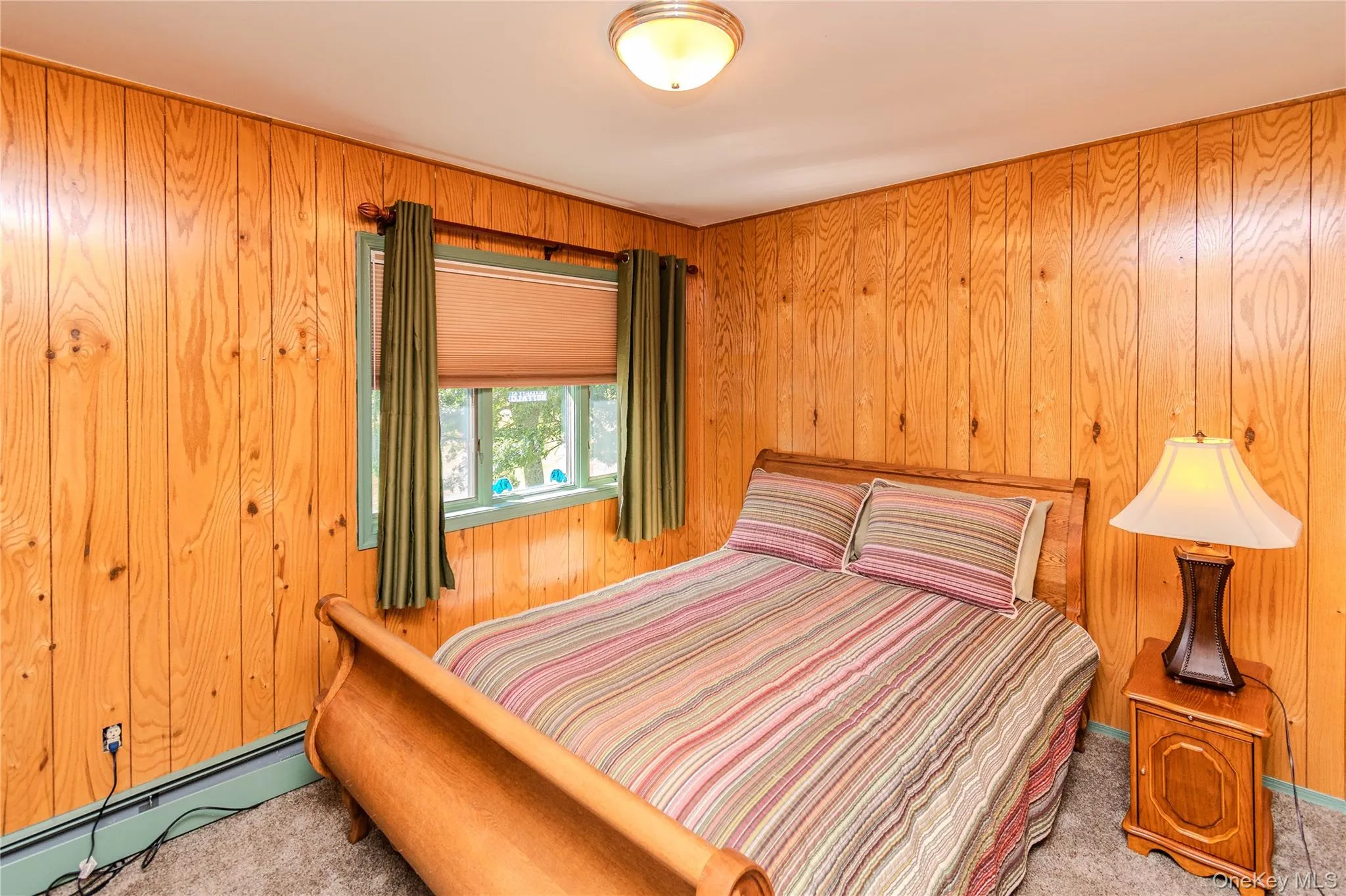 Wood-paneled walls and ceiling-mounted light fixture Wood-paneled walls and ceiling-mounted light fixture