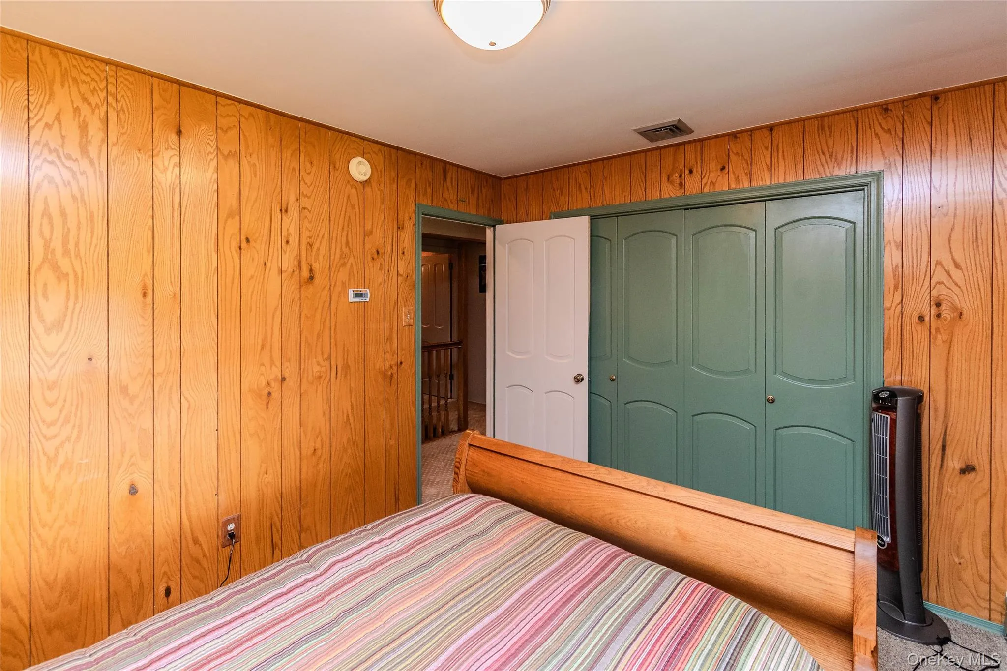 Wood paneling, recessed lighting, carpet flooring, bi-fold closet doors Wood paneling, recessed lighting, carpet flooring, bi-fold closet doors