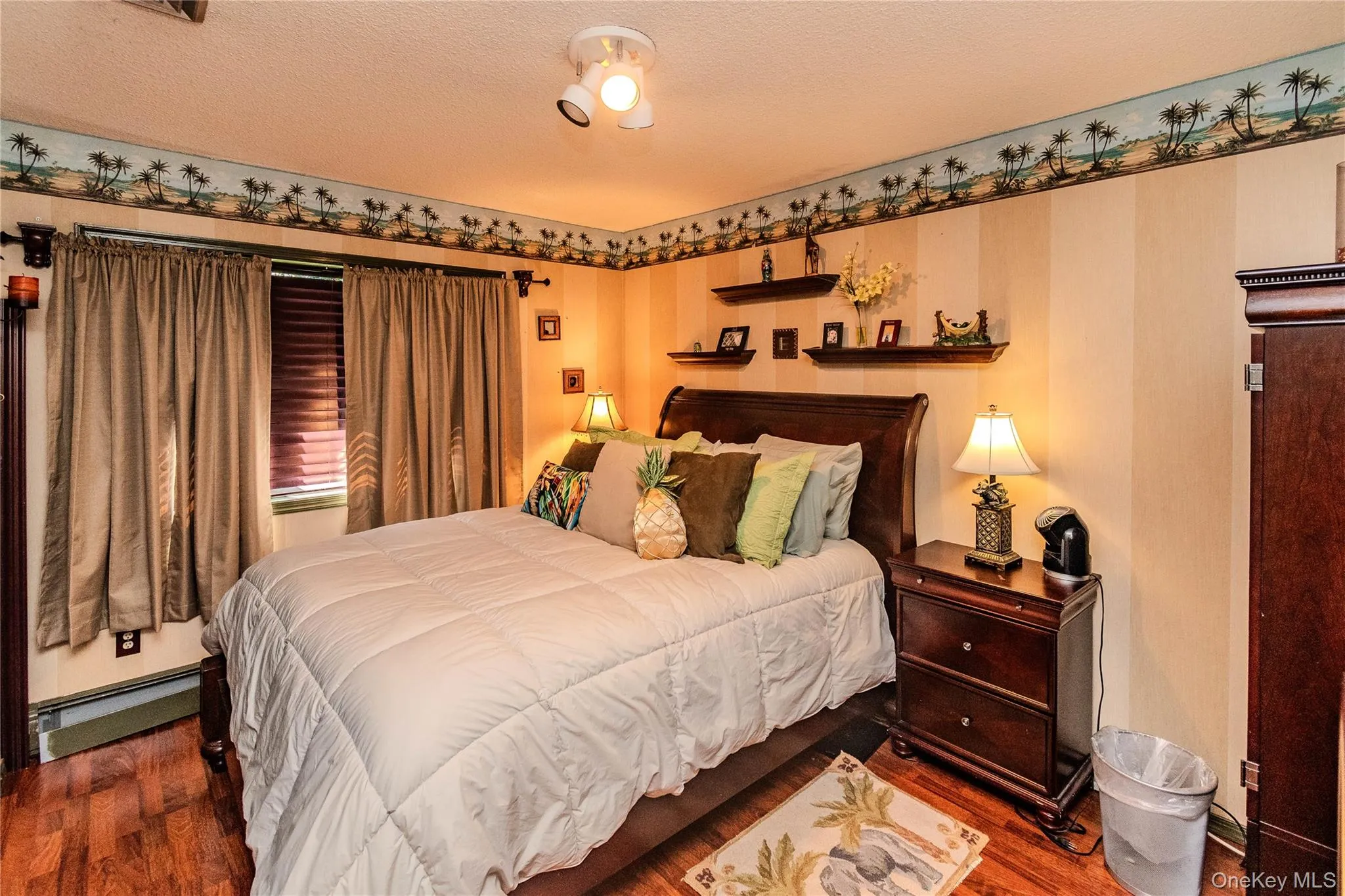 Wood-finish flooring with a decorative border and track lighting Wood-finish flooring with a decorative border and track lighting