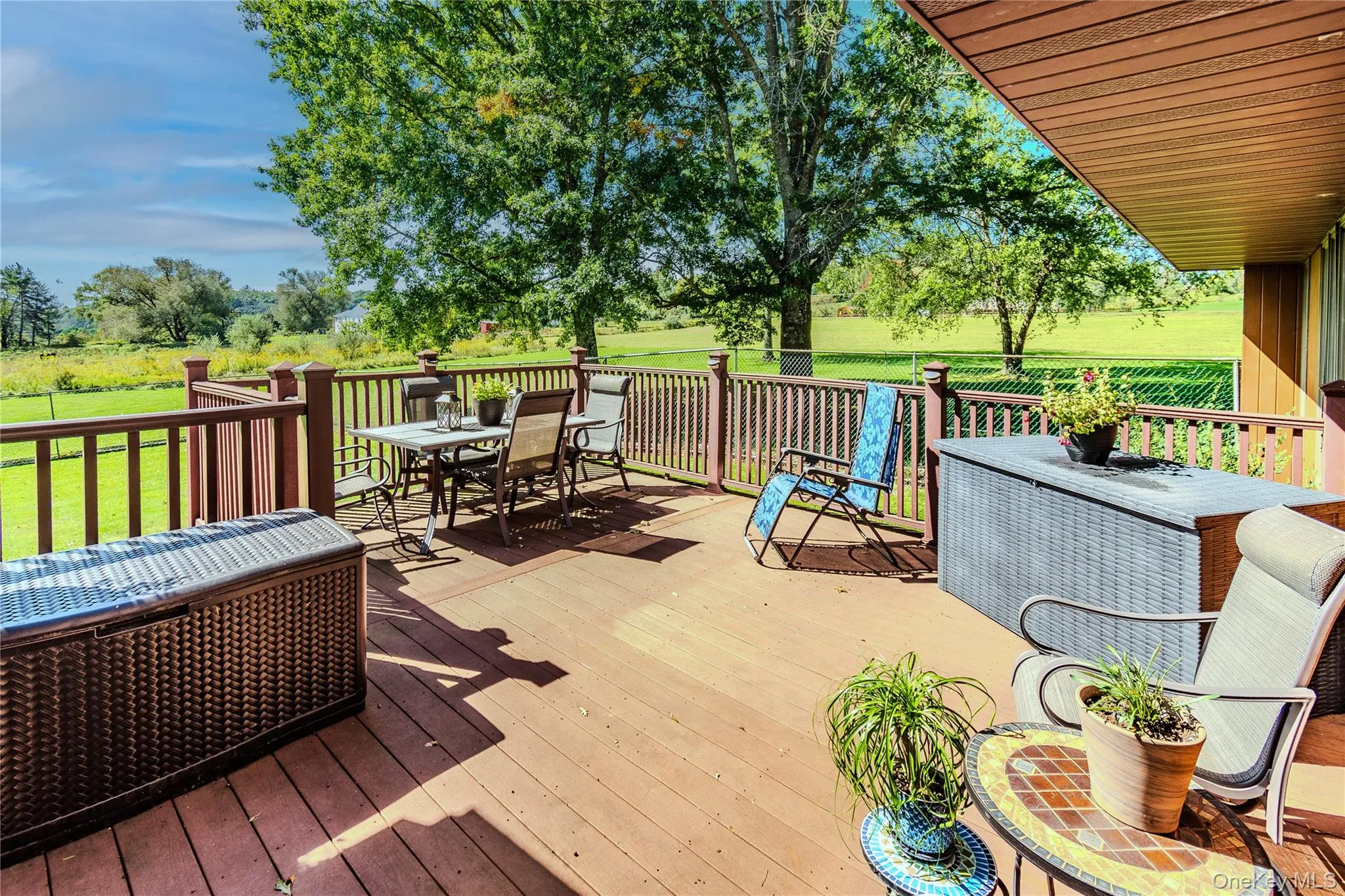 Expansive outdoor deck with wood-finish decking and perimeter railing Expansive outdoor deck with wood-finish decking and perimeter railing