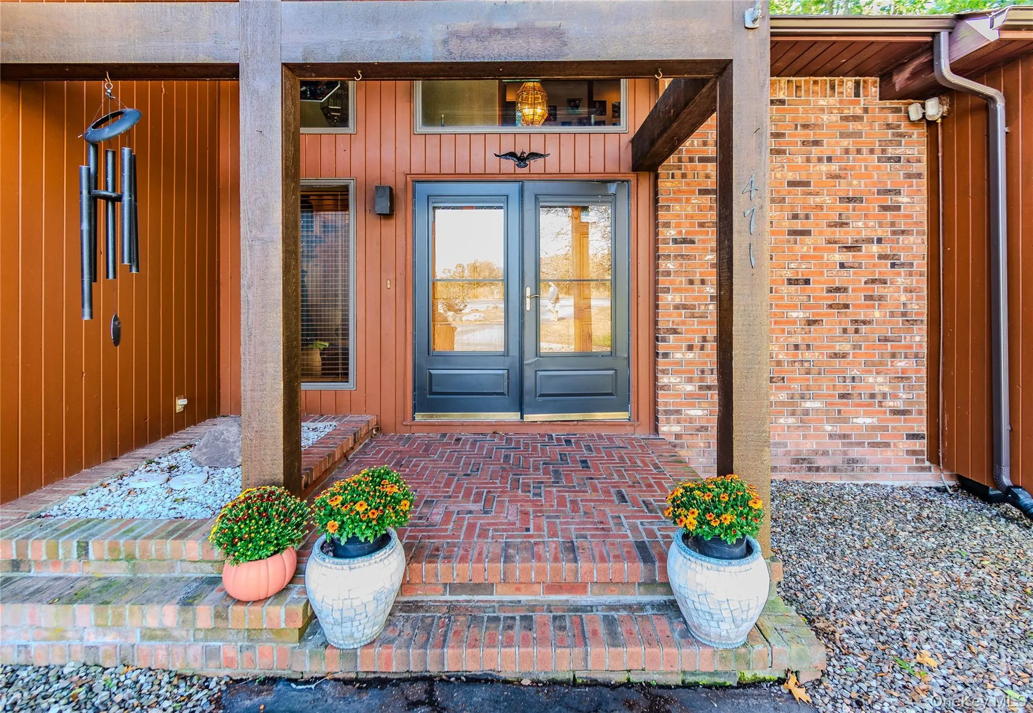 Brick and vertical wood siding exterior with a covered entry Brick and vertical wood siding exterior with a covered entry