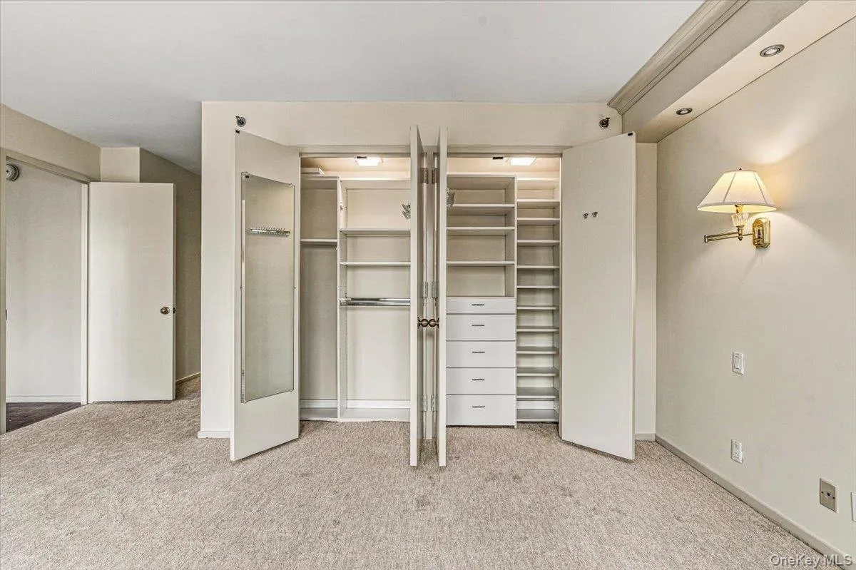 Primary Bedroom Closet with Custom Closet System Primary Bedroom Closet with Custom Closet System