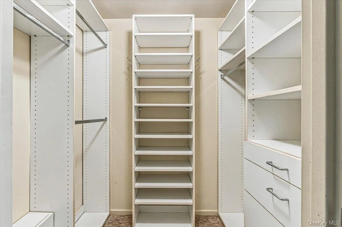 Primary Bedroom Walk-in Closet Primary Bedroom Walk-in Closet