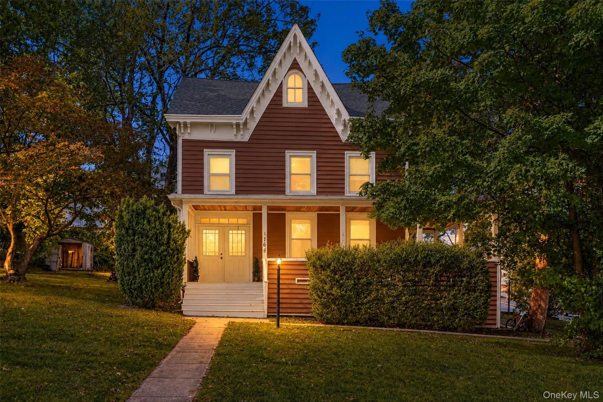 Architectural facade featuring a prominent gable roof and rich siding Architectural facade featuring a prominent gable roof and rich siding