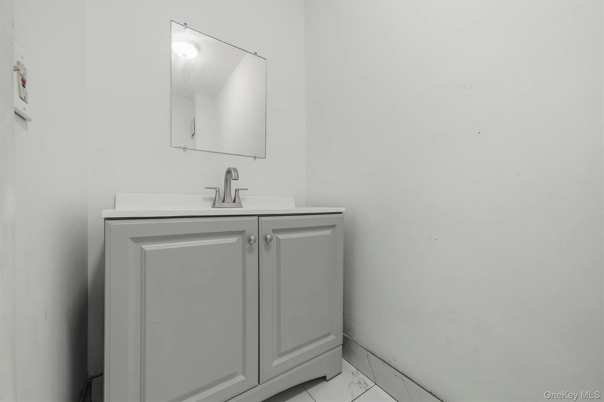 Freestanding vanity with panel cabinetry and brushed nickel hardware Freestanding vanity with panel cabinetry and brushed nickel hardware