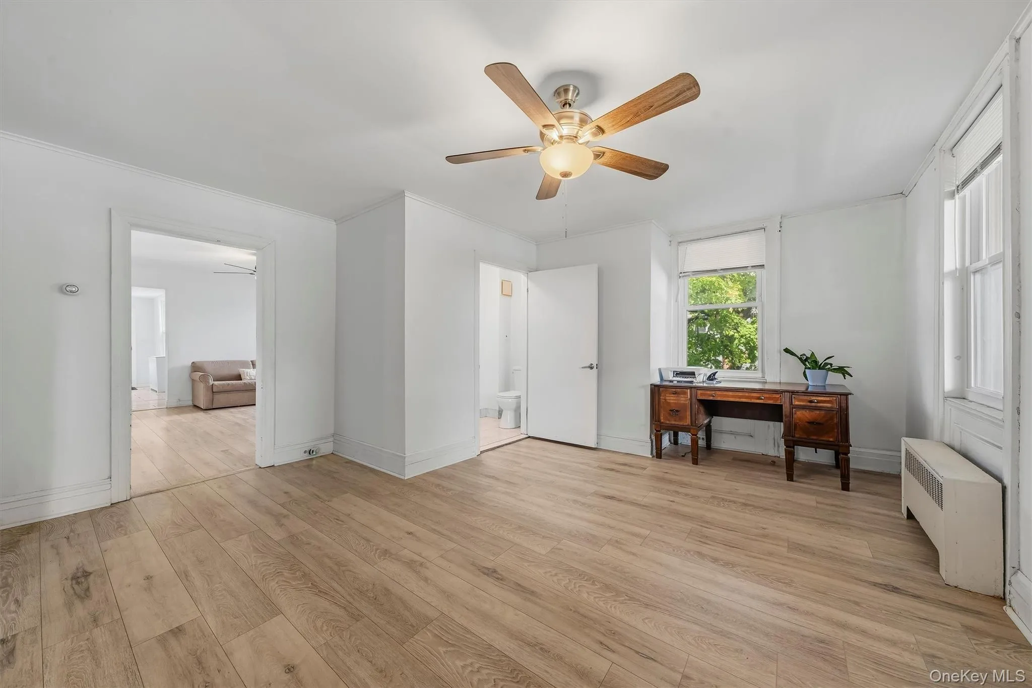 Spacious office with multiple windows, ceiling fan, and plenty of natural light. Spacious office with multiple windows, ceiling fan, and plenty of natural light.