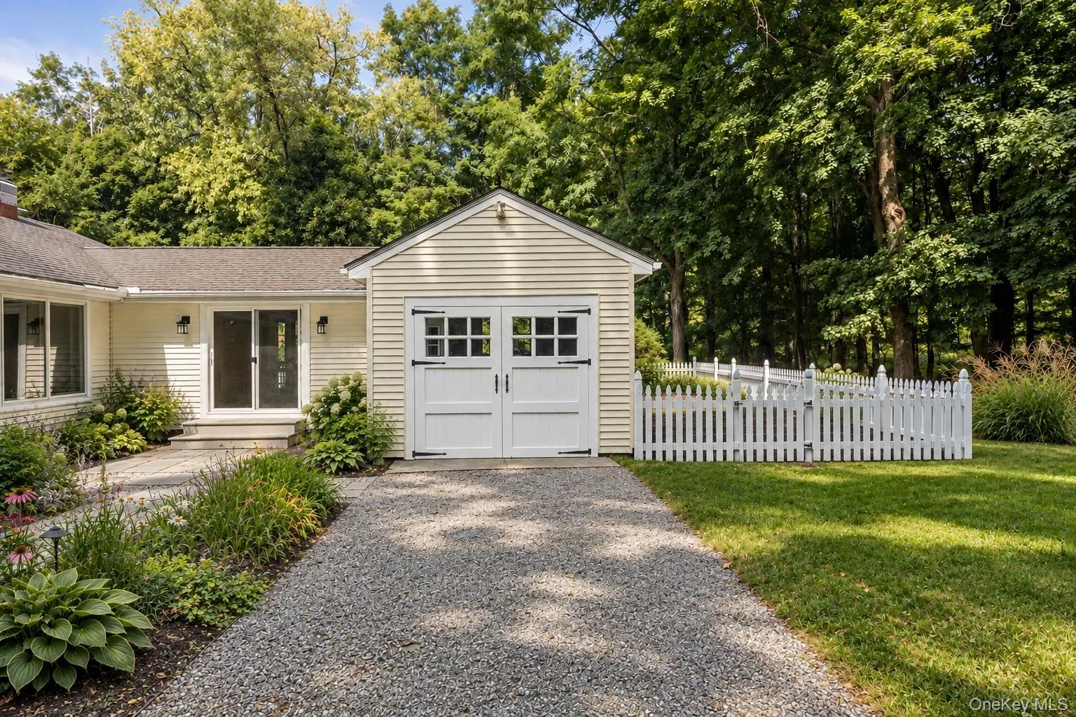 Courtyard entrance is framed by a charming 1 car garage Courtyard entrance is framed by a charming 1 car garage