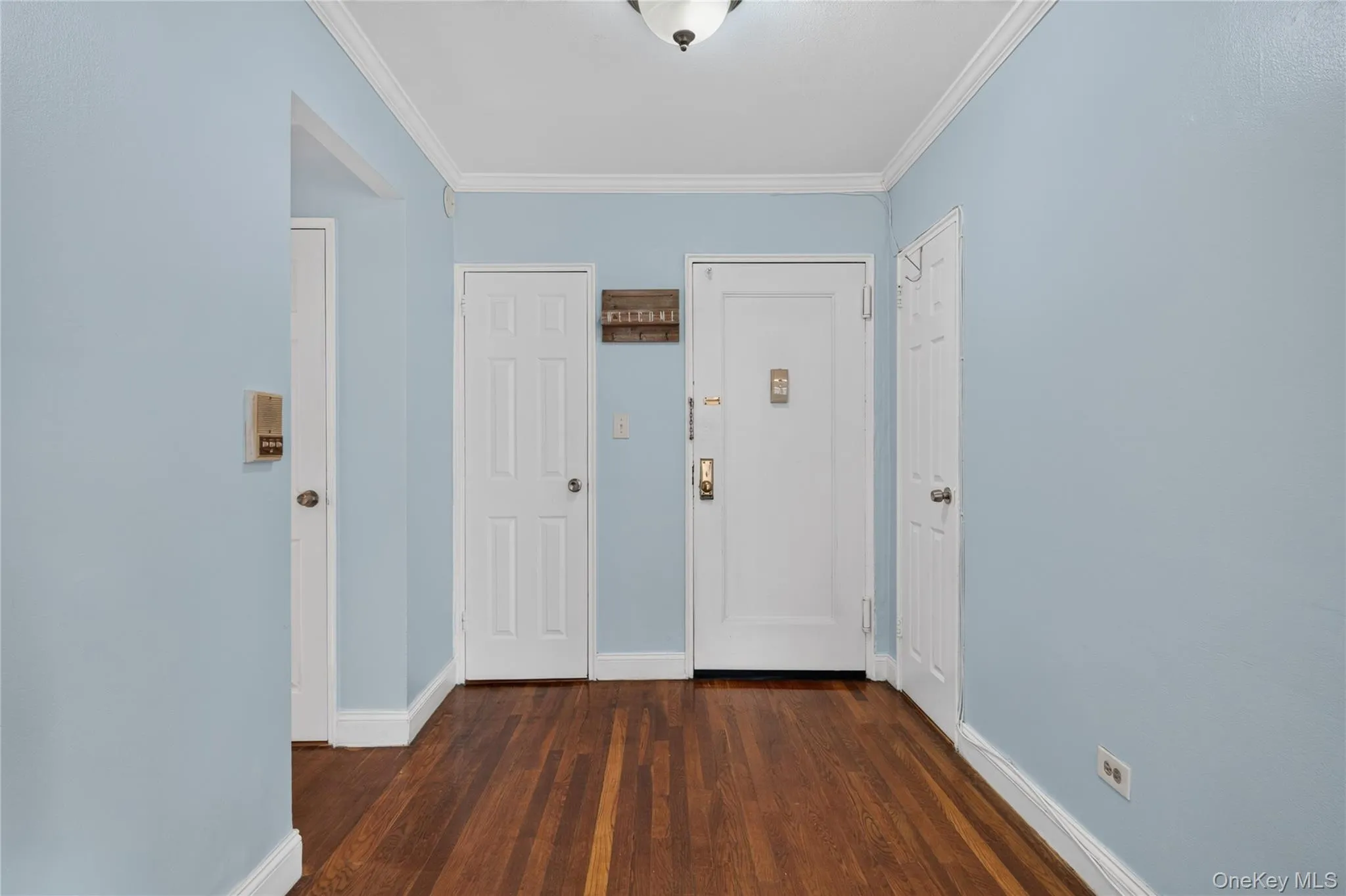 Rich wood-finish flooring, crisp white trim, and a ceiling-mounted light fixture Rich wood-finish flooring, crisp white trim, and a ceiling-mounted light fixture