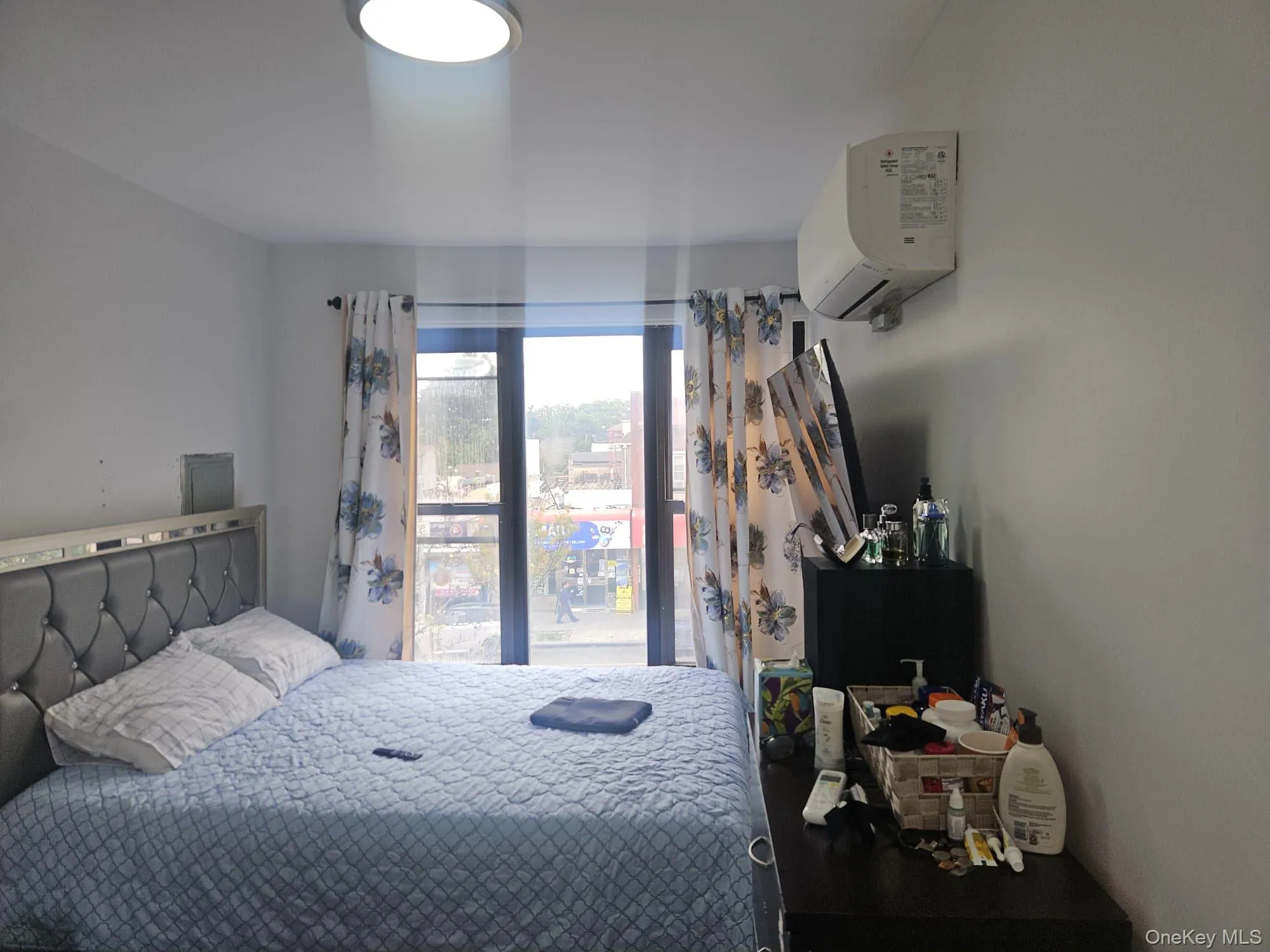 Wall-mounted air conditioning unit, ceiling-mounted light fixture, and glass-paneled exterior door Wall-mounted air conditioning unit, ceiling-mounted light fixture, and glass-paneled exterior door