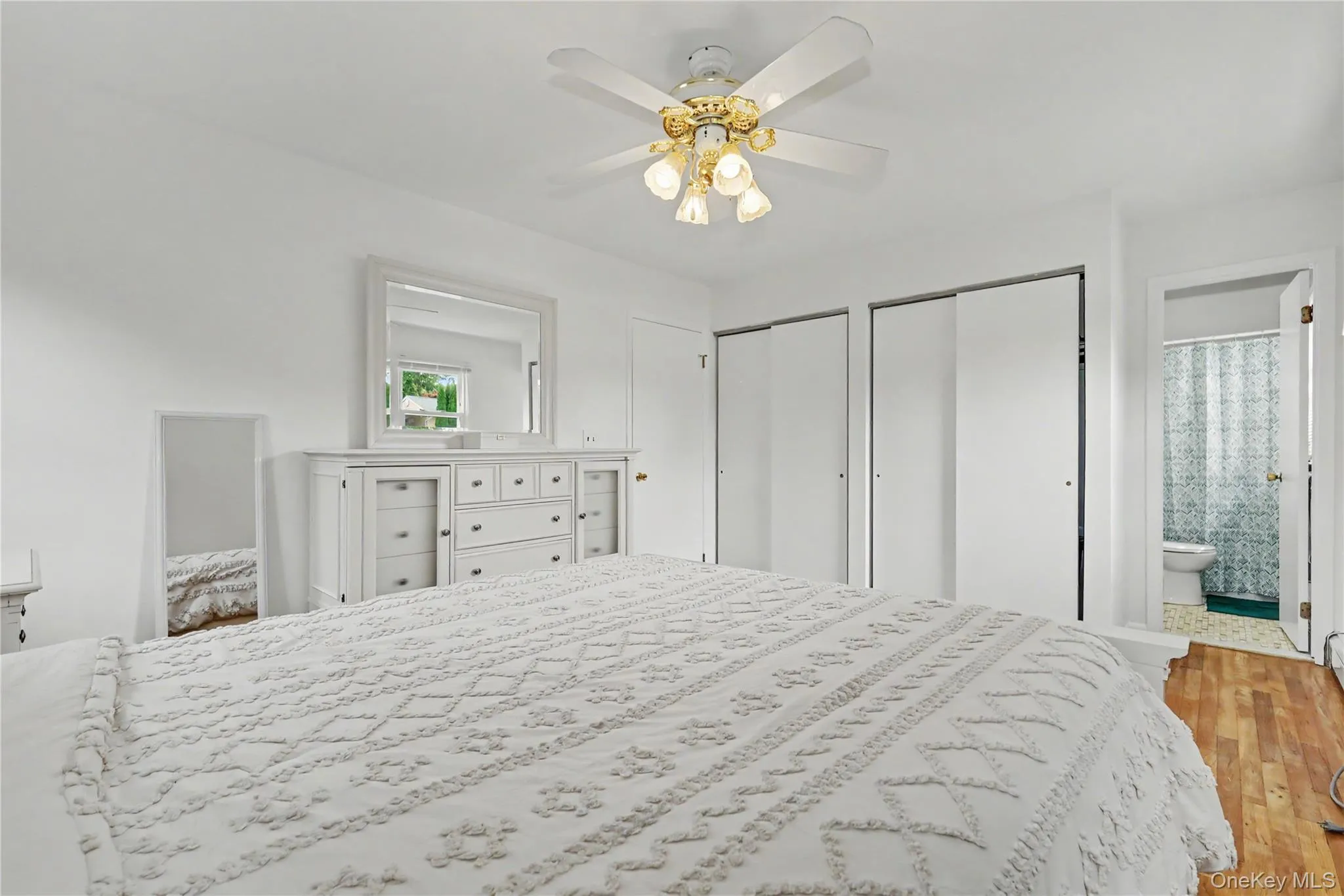 Substantially sized primary bedroom with his and hers closets Substantially sized primary bedroom with his and hers closets