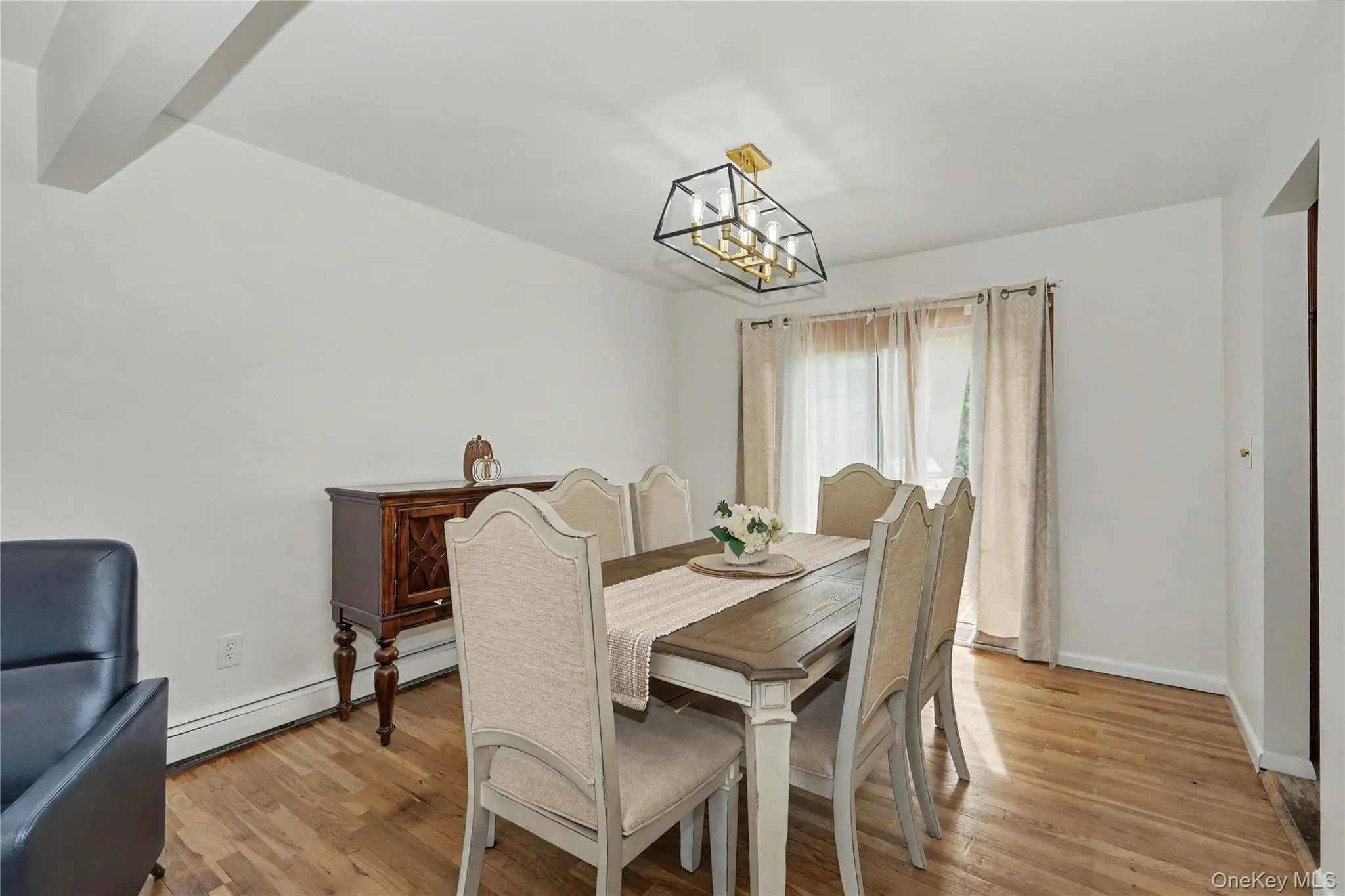Cheerful dining room featuring wood flooring and sliding glass doors to deck over looking large and level back yard Cheerful dining room featuring wood flooring and sliding glass doors to deck over looking large and level back yard