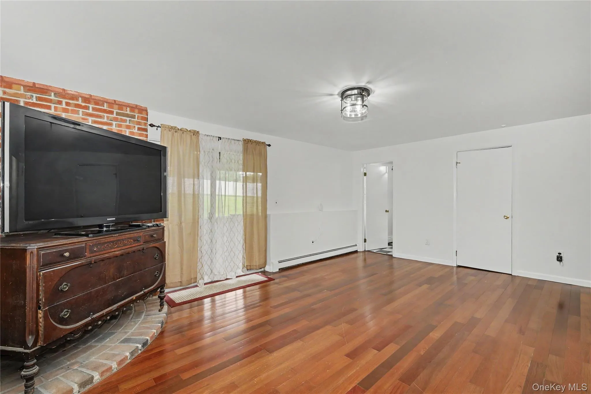 Huge family room with bricked platform for woodburning stove and glass sliders to backyard Huge family room with bricked platform for woodburning stove and glass sliders to backyard