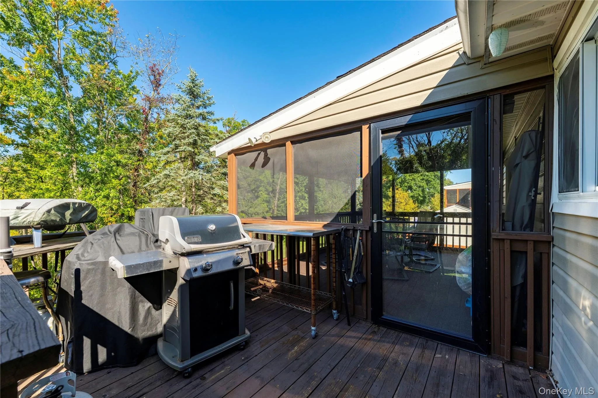 Open Deck featuring wood-finish decking just off the screened-in porch area Open Deck featuring wood-finish decking just off the screened-in porch area