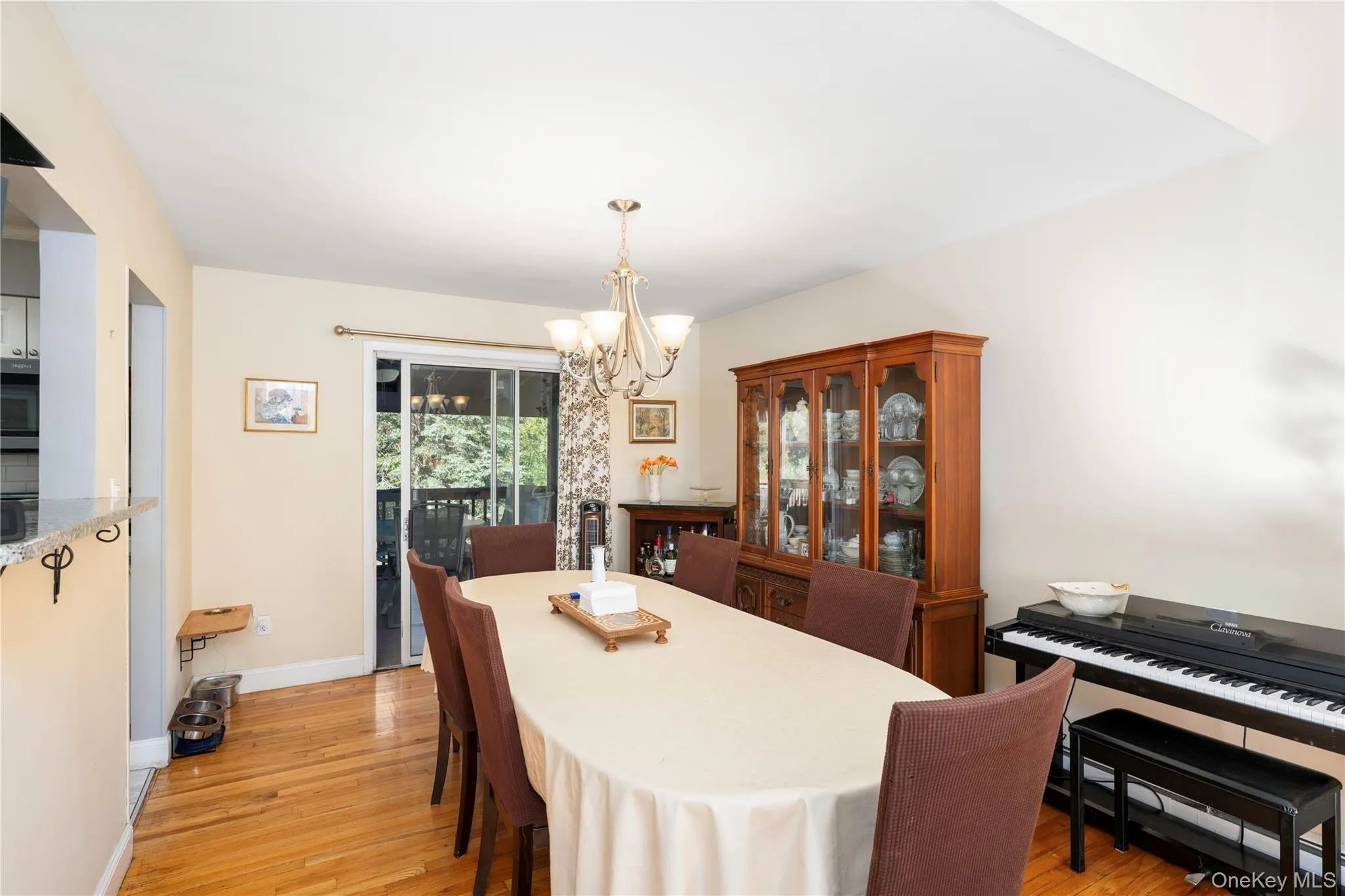Hardwood flooring, sliding glass door, pendant light fixture, and a built-in display cabinet Hardwood flooring, sliding glass door, pendant light fixture, and a built-in display cabinet