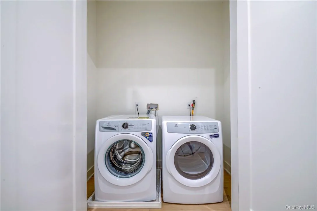 Laundry room featuring light hardwood / wood-style floors and independent washer and dryer Laundry room featuring light hardwood / wood-style floors and independent washer and dryer