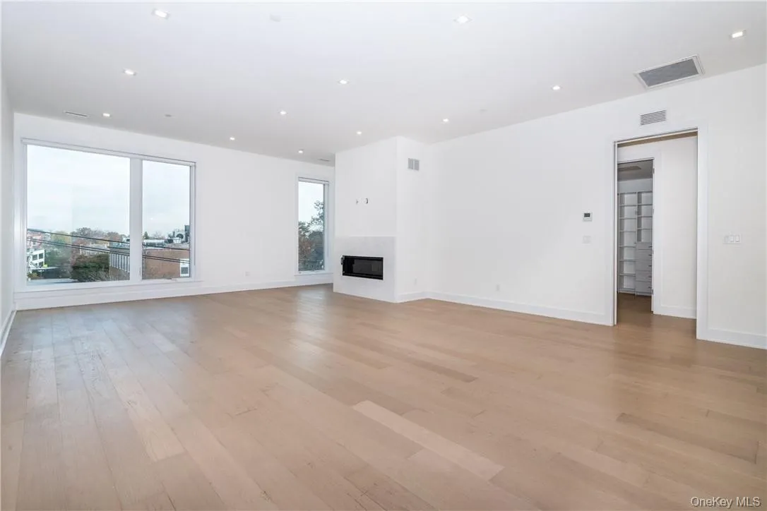 Unfurnished living room featuring light hardwood / wood-style flooring Unfurnished living room featuring light hardwood / wood-style flooring