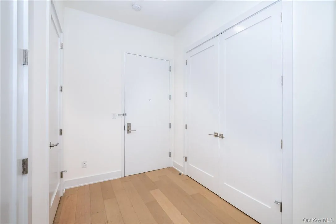 Hallway featuring light hardwood / wood-style floors Hallway featuring light hardwood / wood-style floors