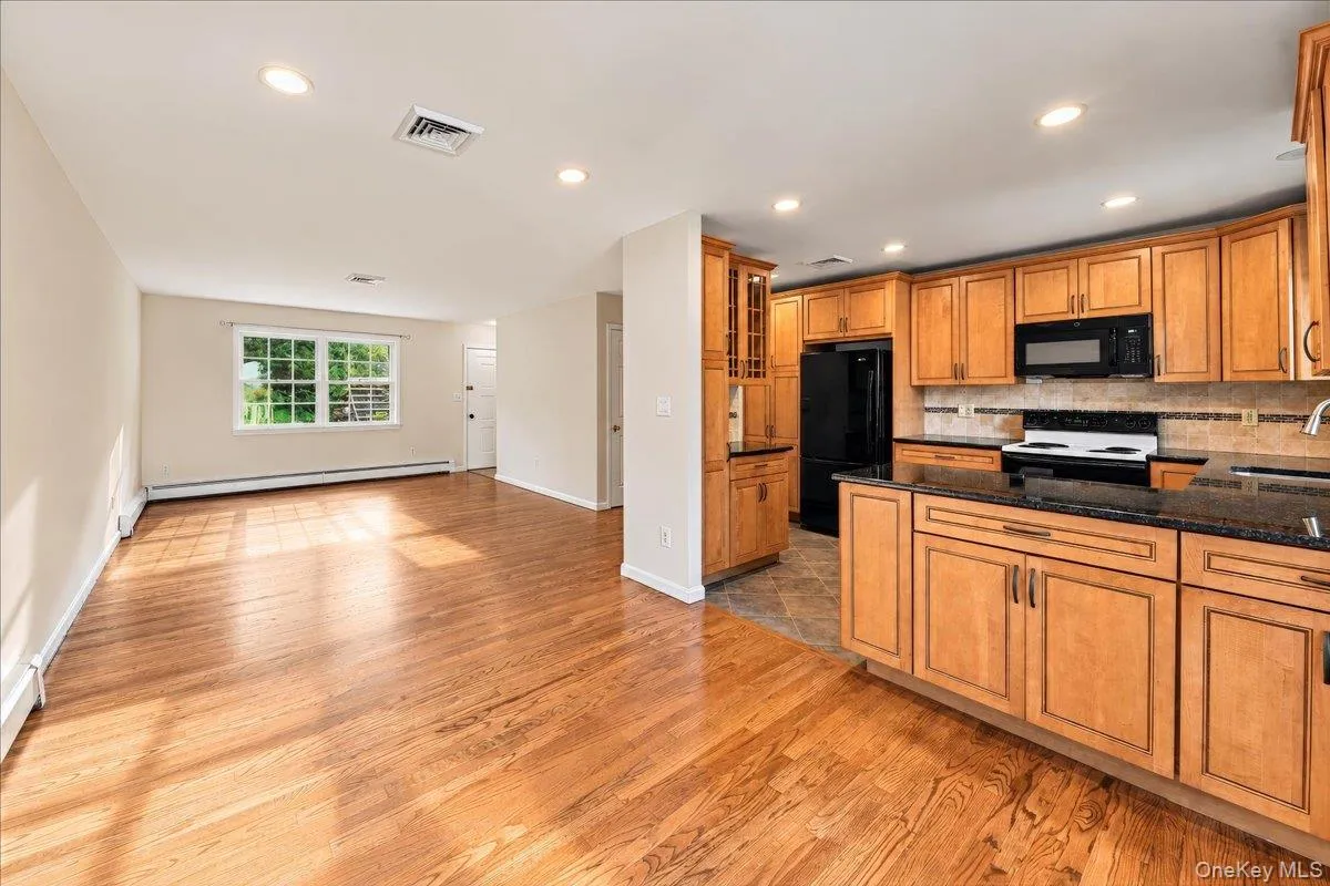 An inviting open floor plan seamlessly connects the kitchen, dining room, and living room, creating a bright and airy space ideal for everyday living and entertaining. An inviting open floor plan seamlessly connects the kitchen, dining room, and living room, creating a bright and airy space ideal for everyday living and entertaining.