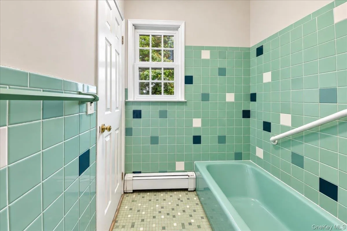 Separate tub area with a private entrance to the primary bedroom, offering added convenience. Separate tub area with a private entrance to the primary bedroom, offering added convenience.