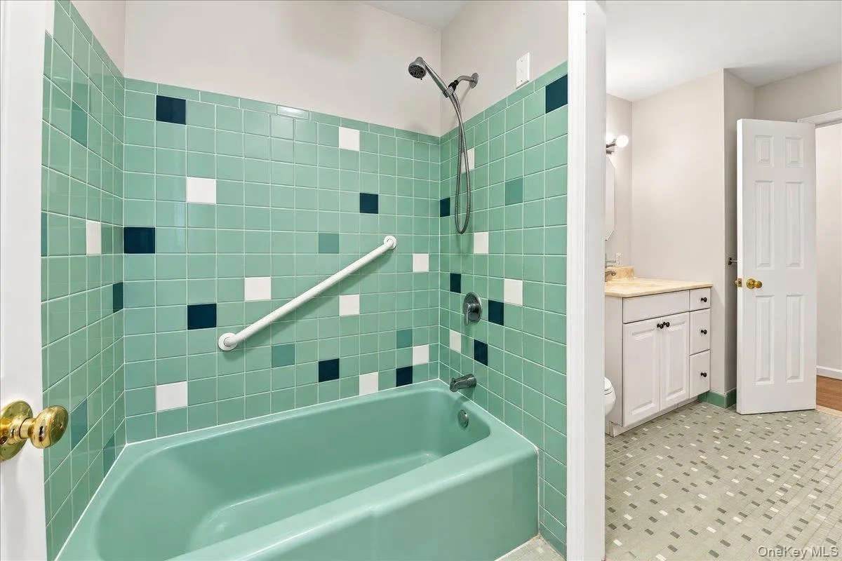 Conveniently designed bathroom with access from both the primary bedroom and hallway, featuring a separate tub area for added functionality and privacy. Conveniently designed bathroom with access from both the primary bedroom and hallway, featuring a separate tub area for added functionality and privacy.