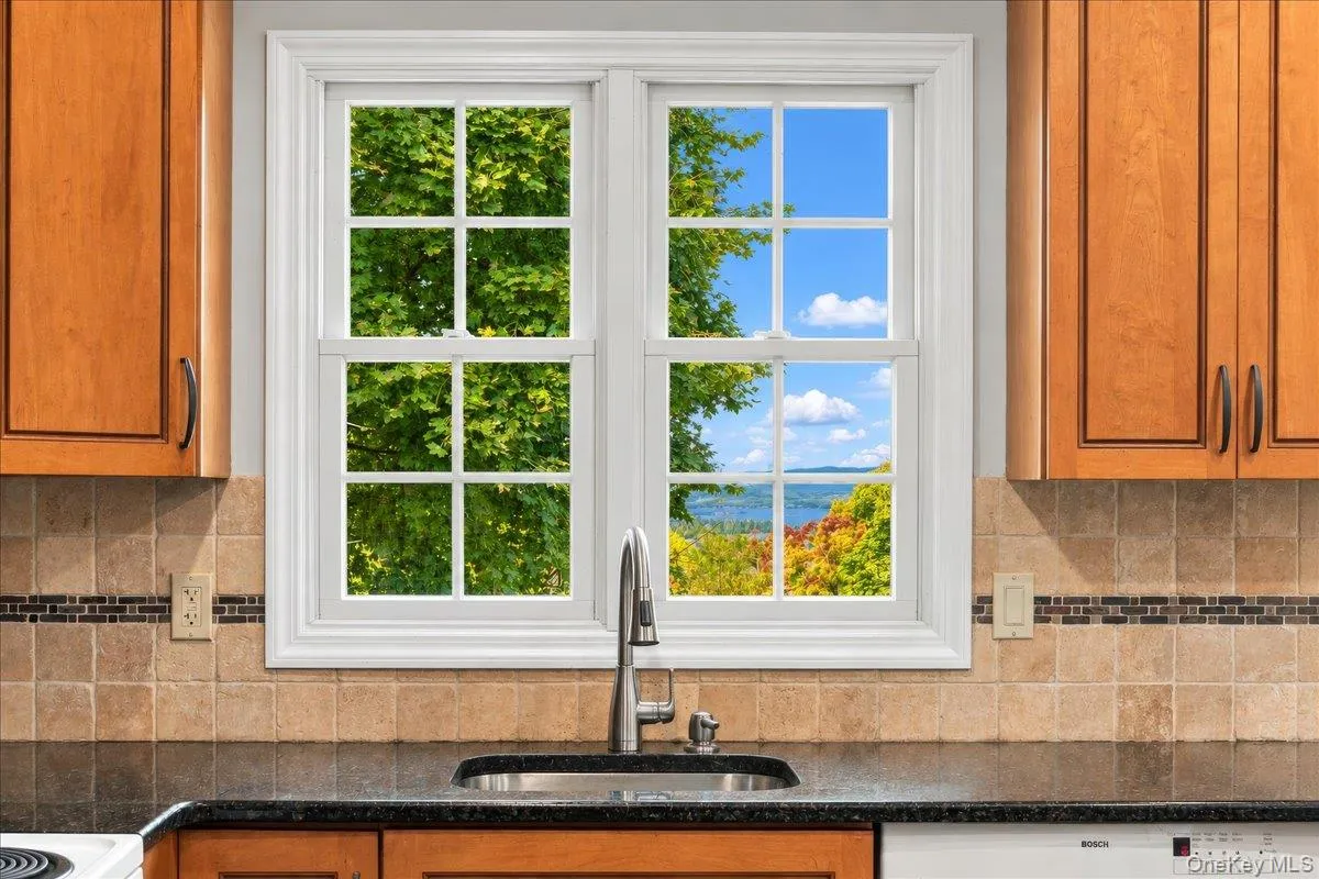 A kitchen window above the sink frames beautiful Hudson River views, making even everyday moments a little more scenic. A kitchen window above the sink frames beautiful Hudson River views, making even everyday moments a little more scenic.