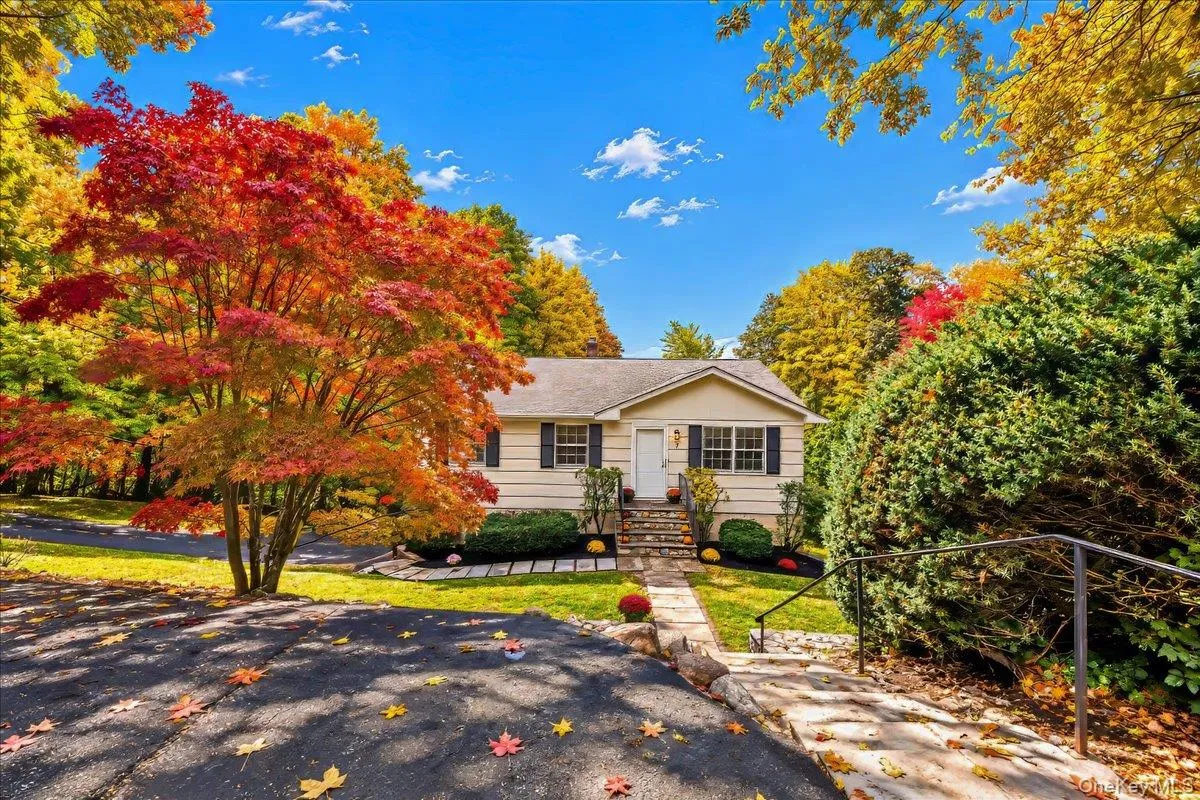Long driveway leading to the garage, with an additional parking space conveniently located at the start of the walkway. Long driveway leading to the garage, with an additional parking space conveniently located at the start of the walkway.