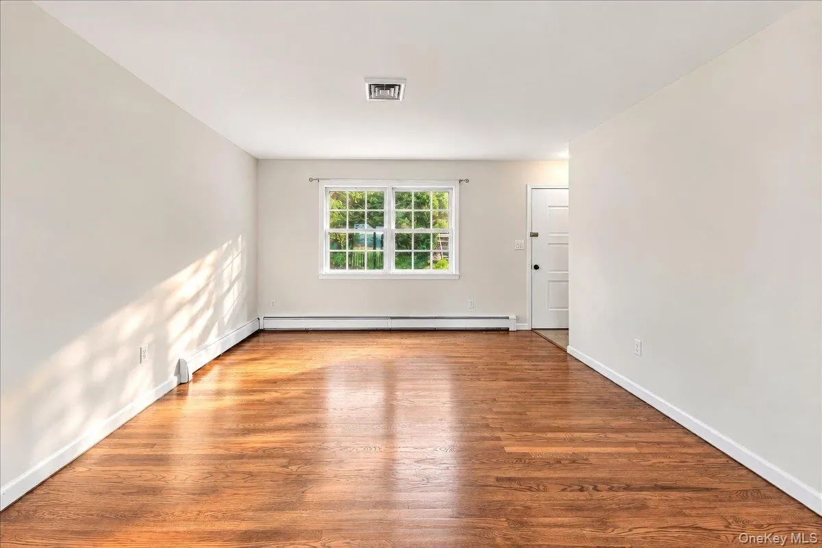 Welcoming entryway opens to a bright, inviting living room featuring beautifully refinished hardwood floors. Welcoming entryway opens to a bright, inviting living room featuring beautifully refinished hardwood floors.