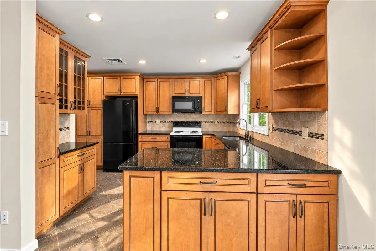 Stone countertops, recessed lighting, and an abundance of cabinet storage and counter space make this kitchen both functional and inviting. Stone countertops, recessed lighting, and an abundance of cabinet storage and counter space make this kitchen both functional and inviting.